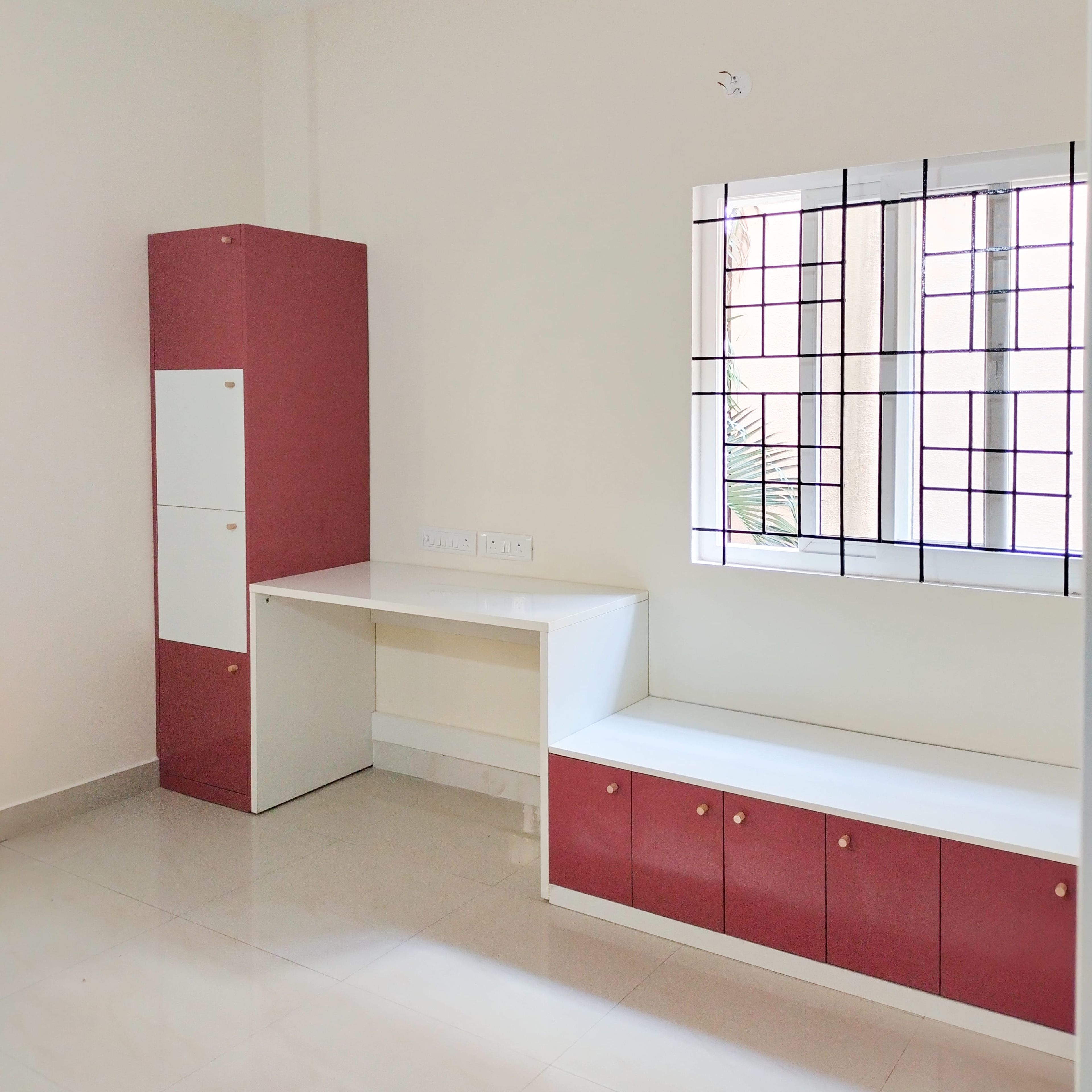 Peach and white study space with tall unit