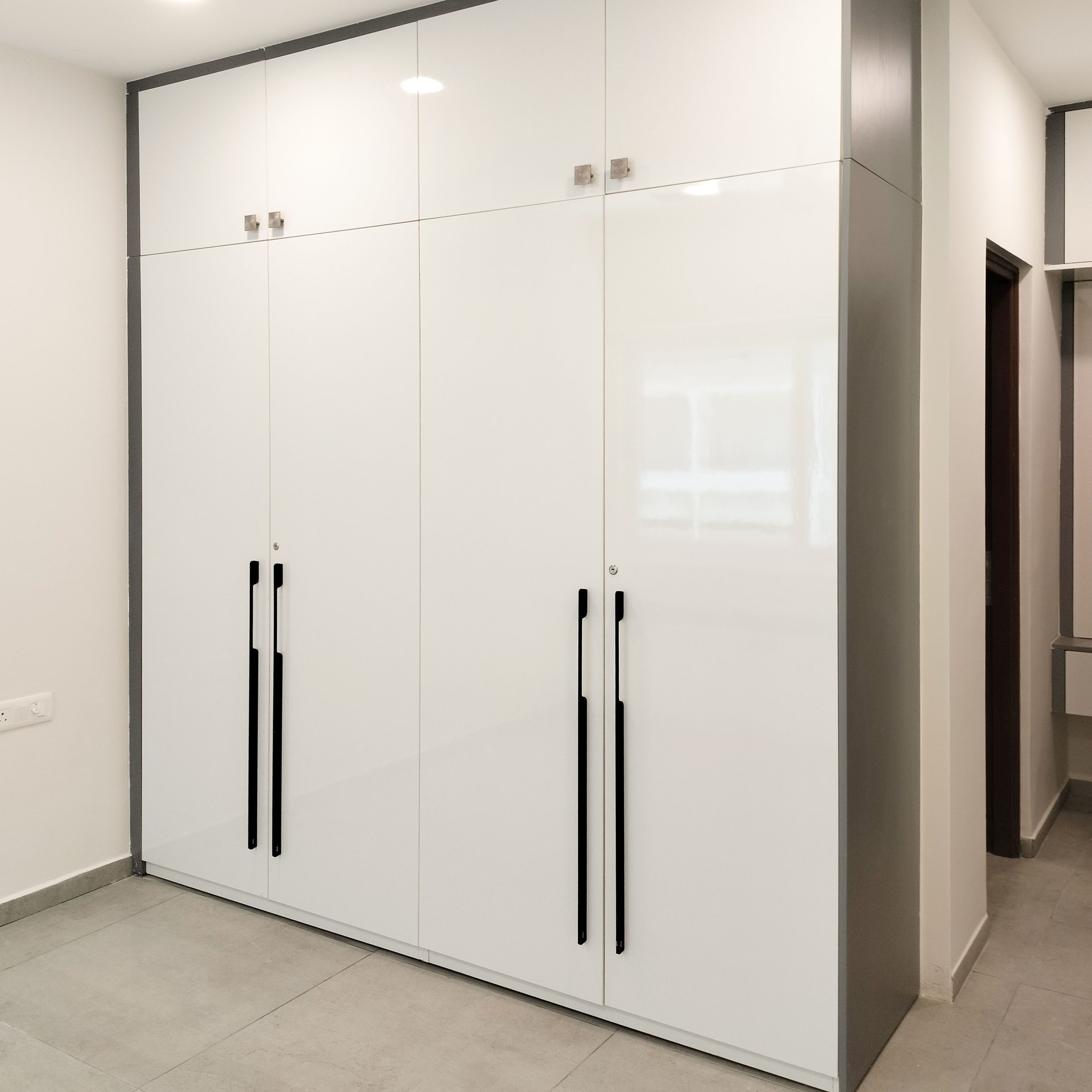 4-Door White Swing Wardrobe Design with Loft Unit