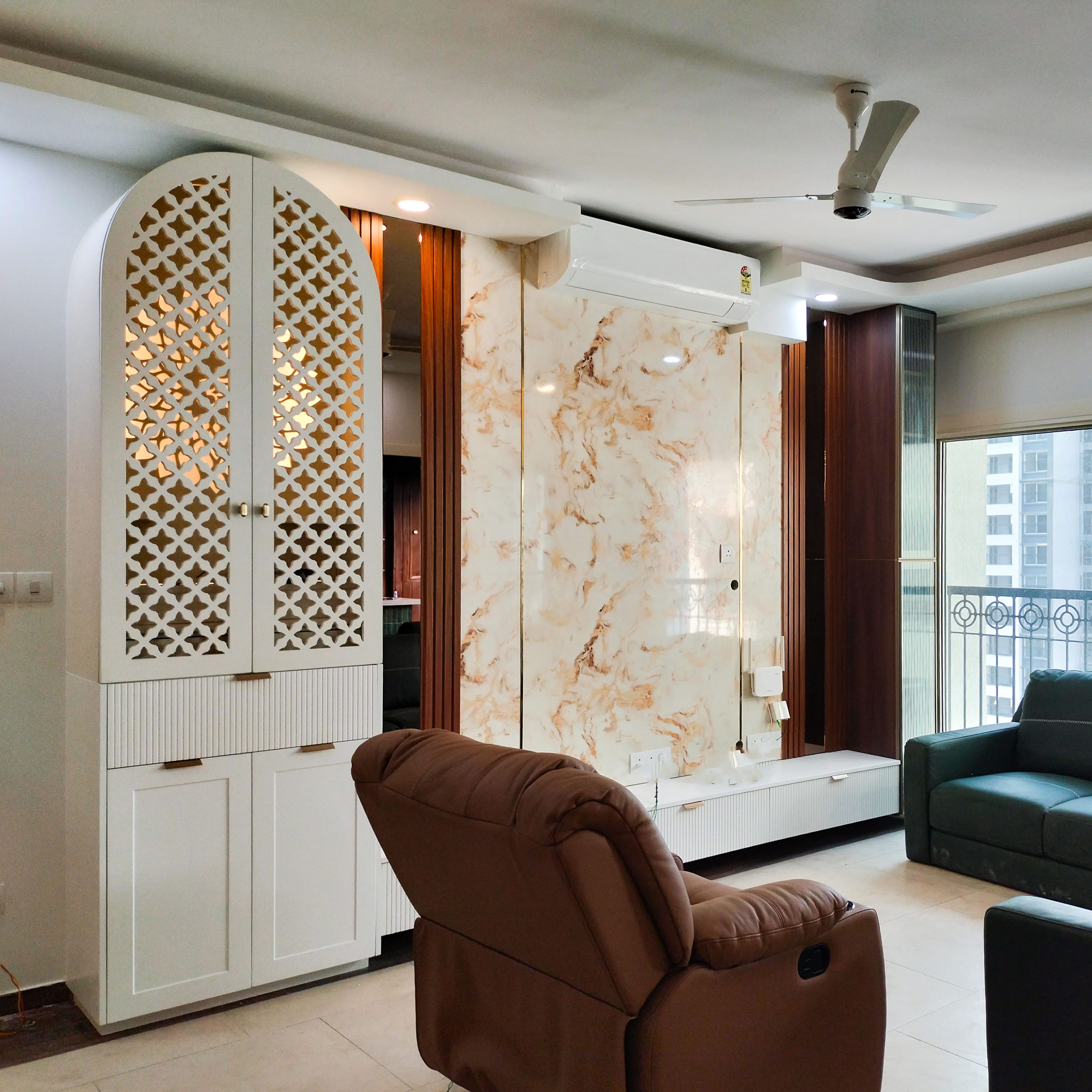 Living room with white pooja unit and TV unit