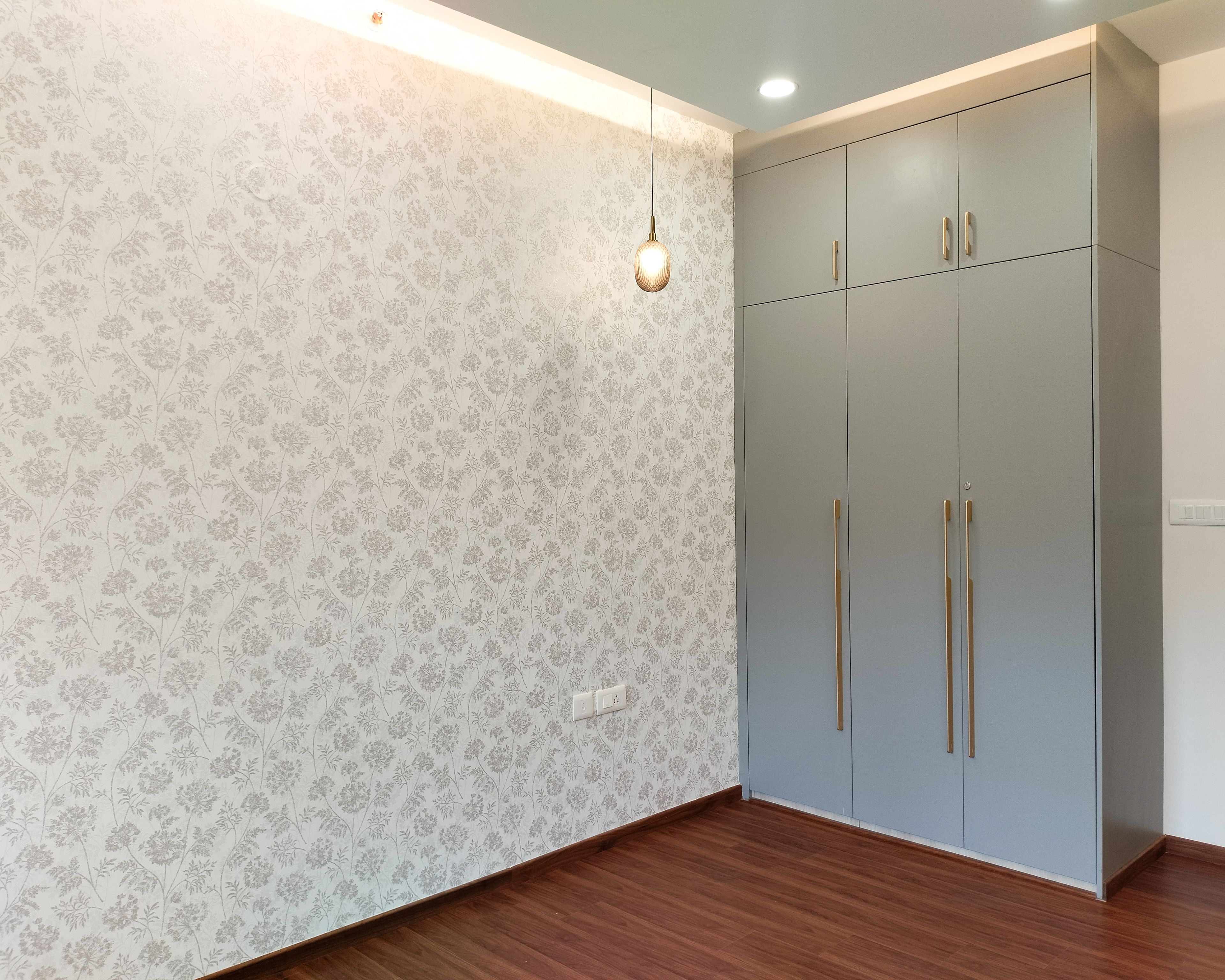 Bedroom Design with Floral Prints Wallpaper and 3-Door Grey Swing Wardrobe