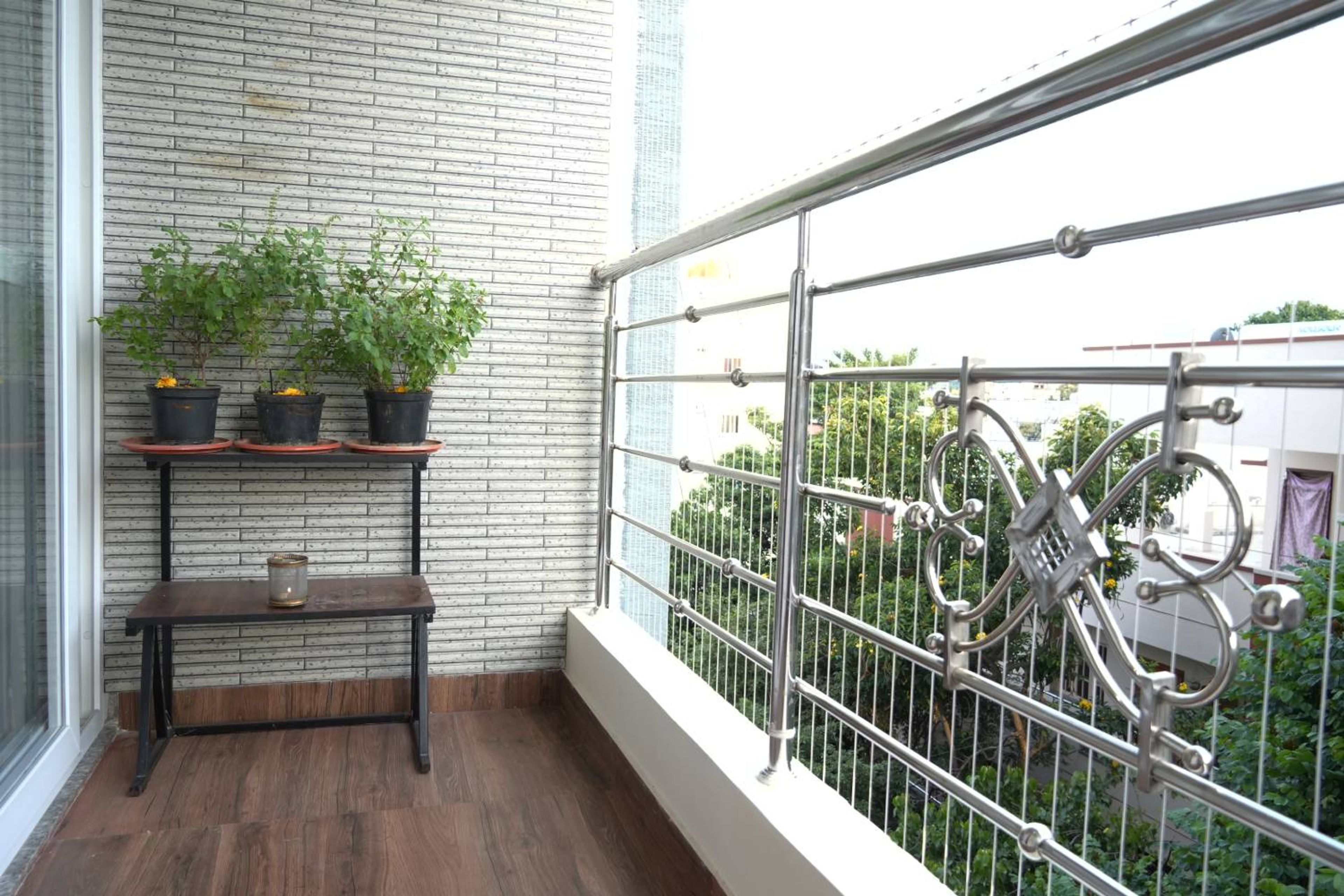 Balcony Design With Stone Cladding And Green Herb Garden