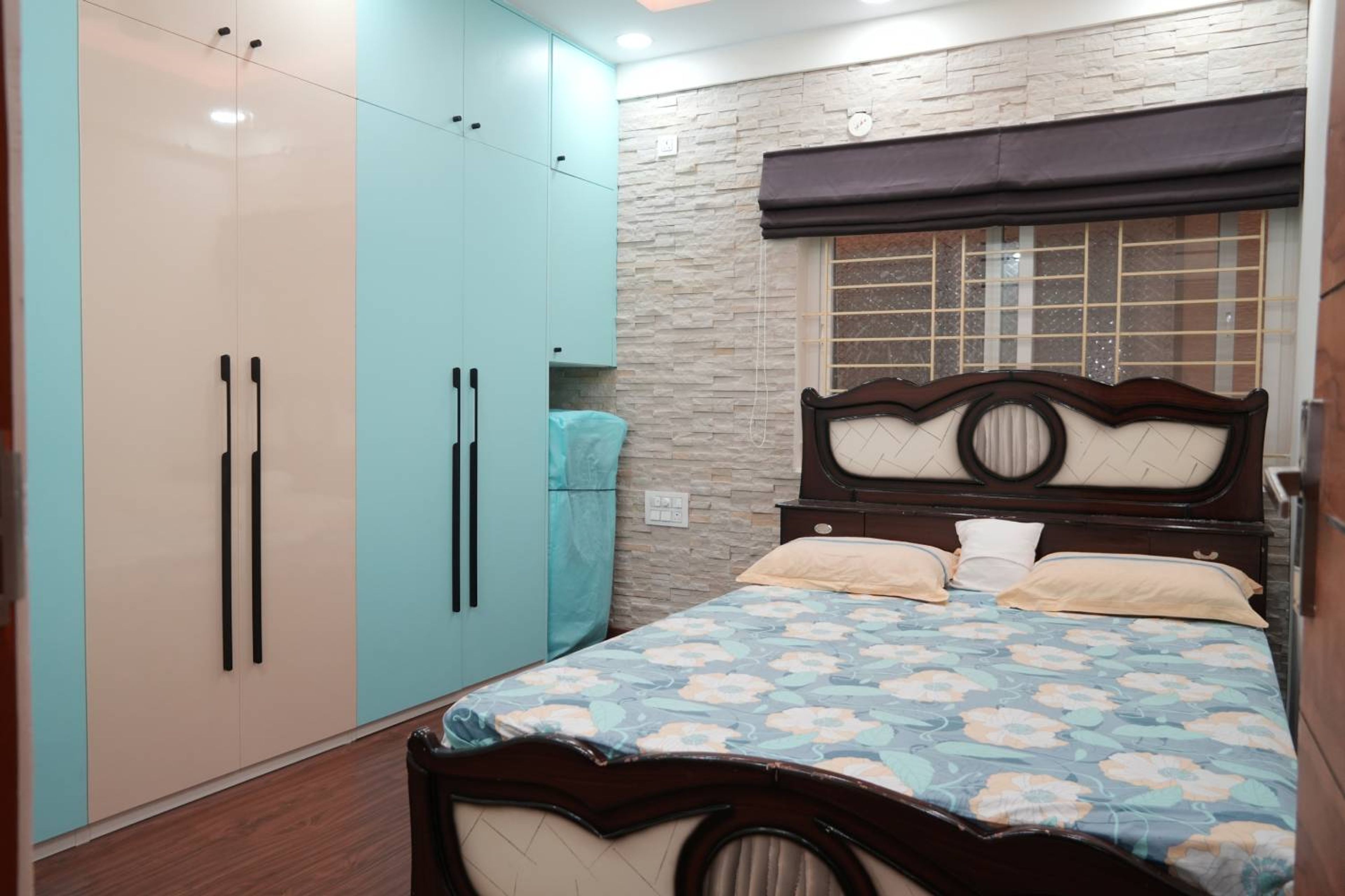 Contemporary Guest Bedroom Design with Aqua Palette and Stone Accent Wall