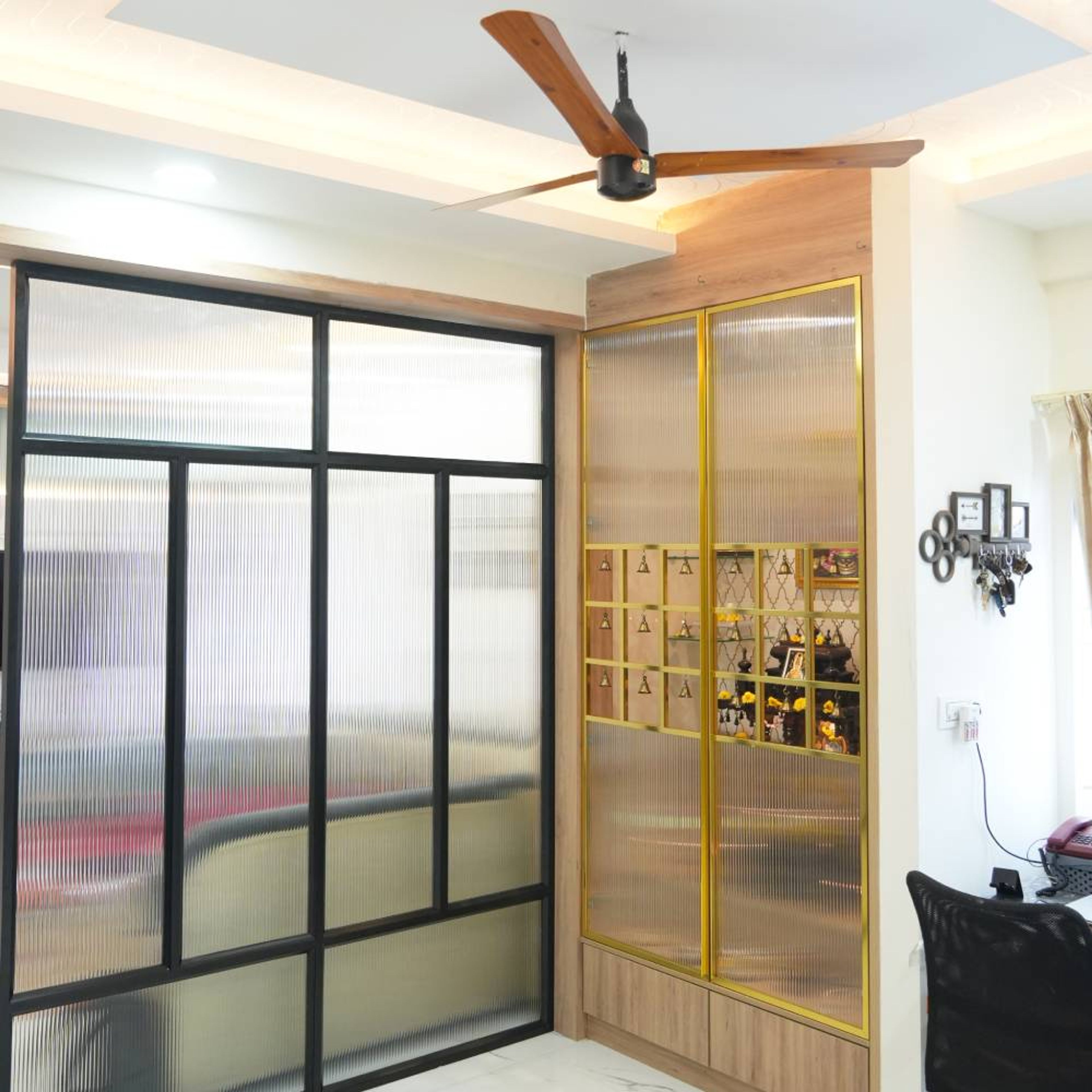 Tall Contemporary Pooja Design With Gold Glass Doors