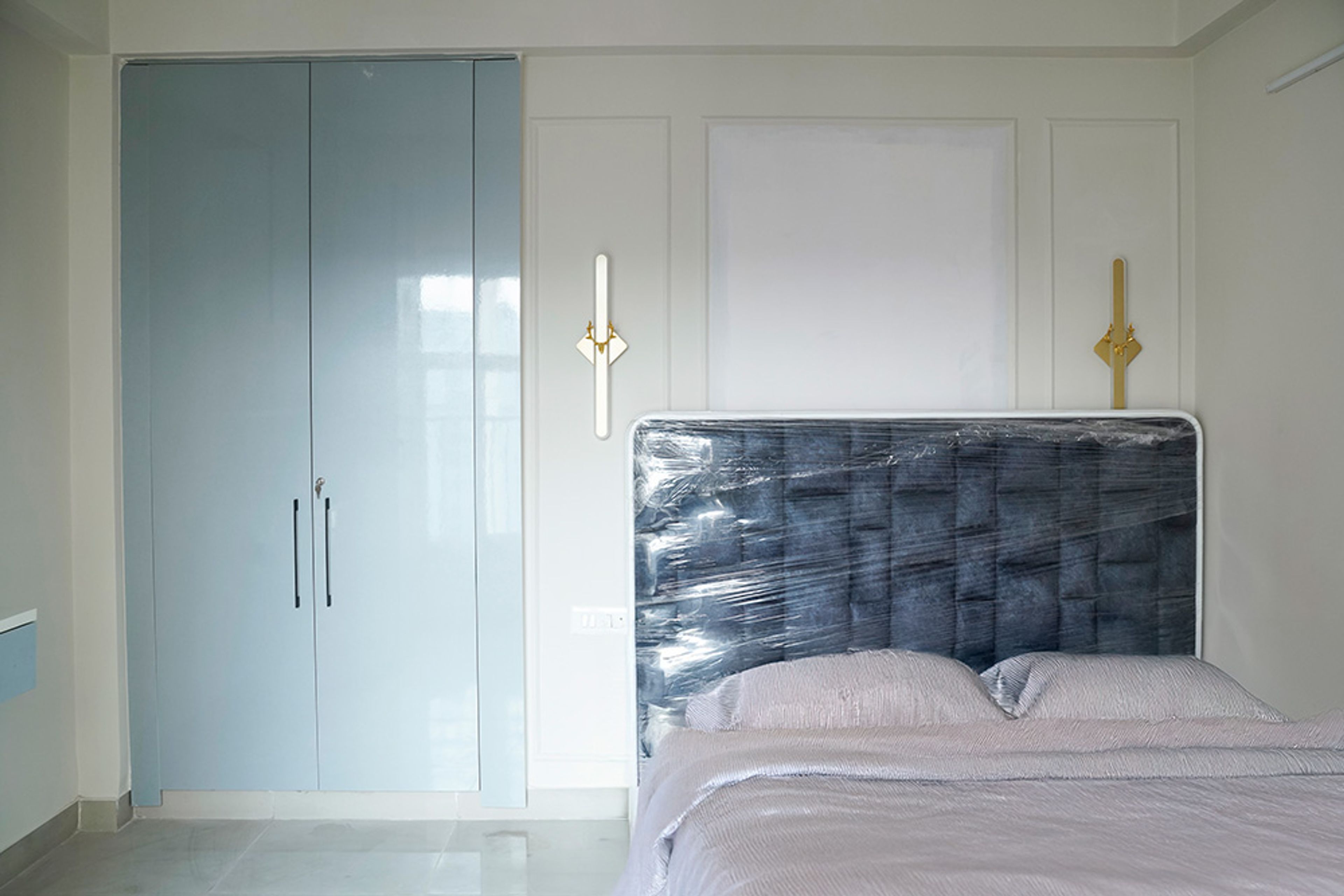 Bedroom Design with Dark Blue Tufted Headboard Bed and Pastel Blue 2-Door Swing Wardrobe