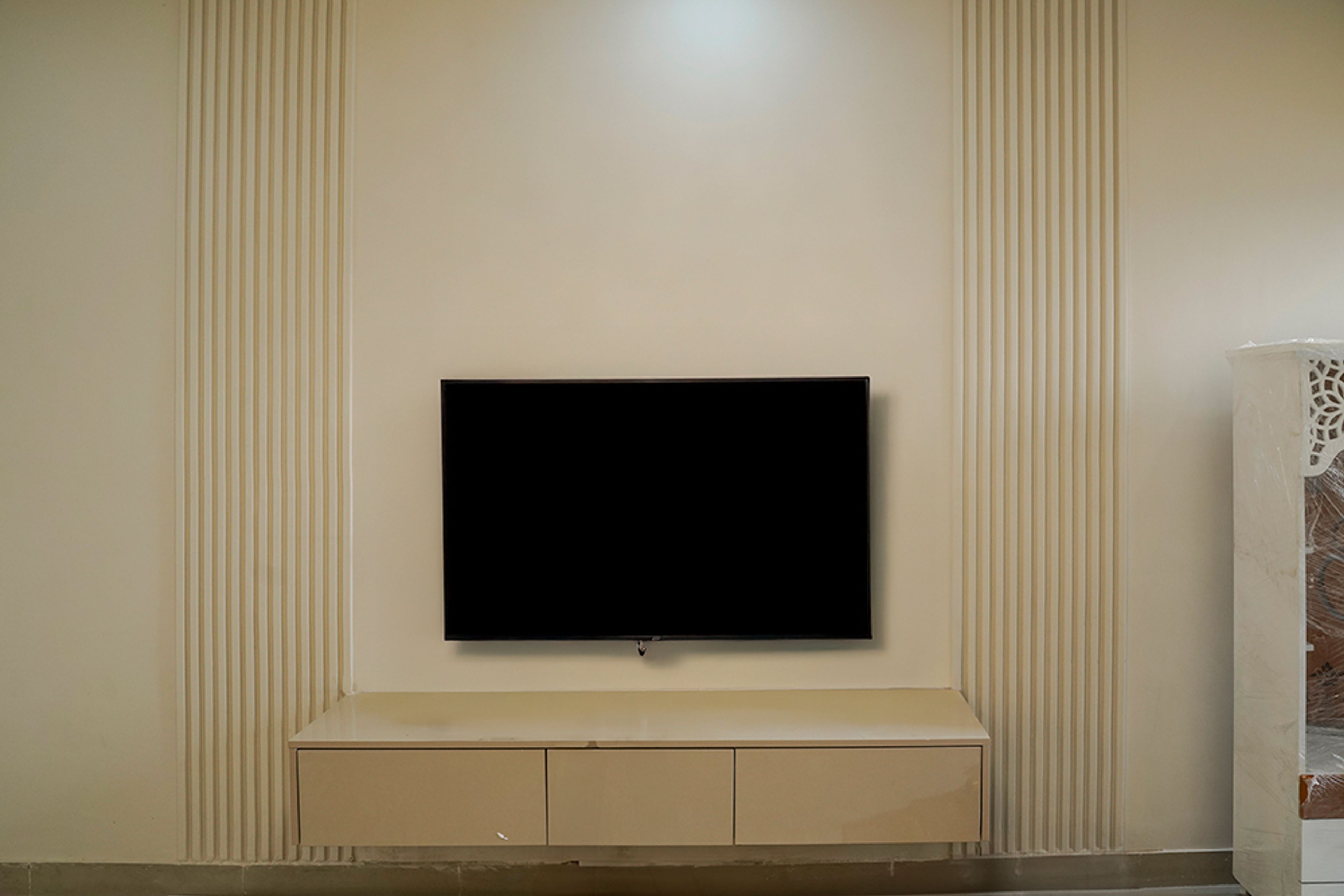 TV Unit Design with Cream Wall with Grooves and Beige Drawers