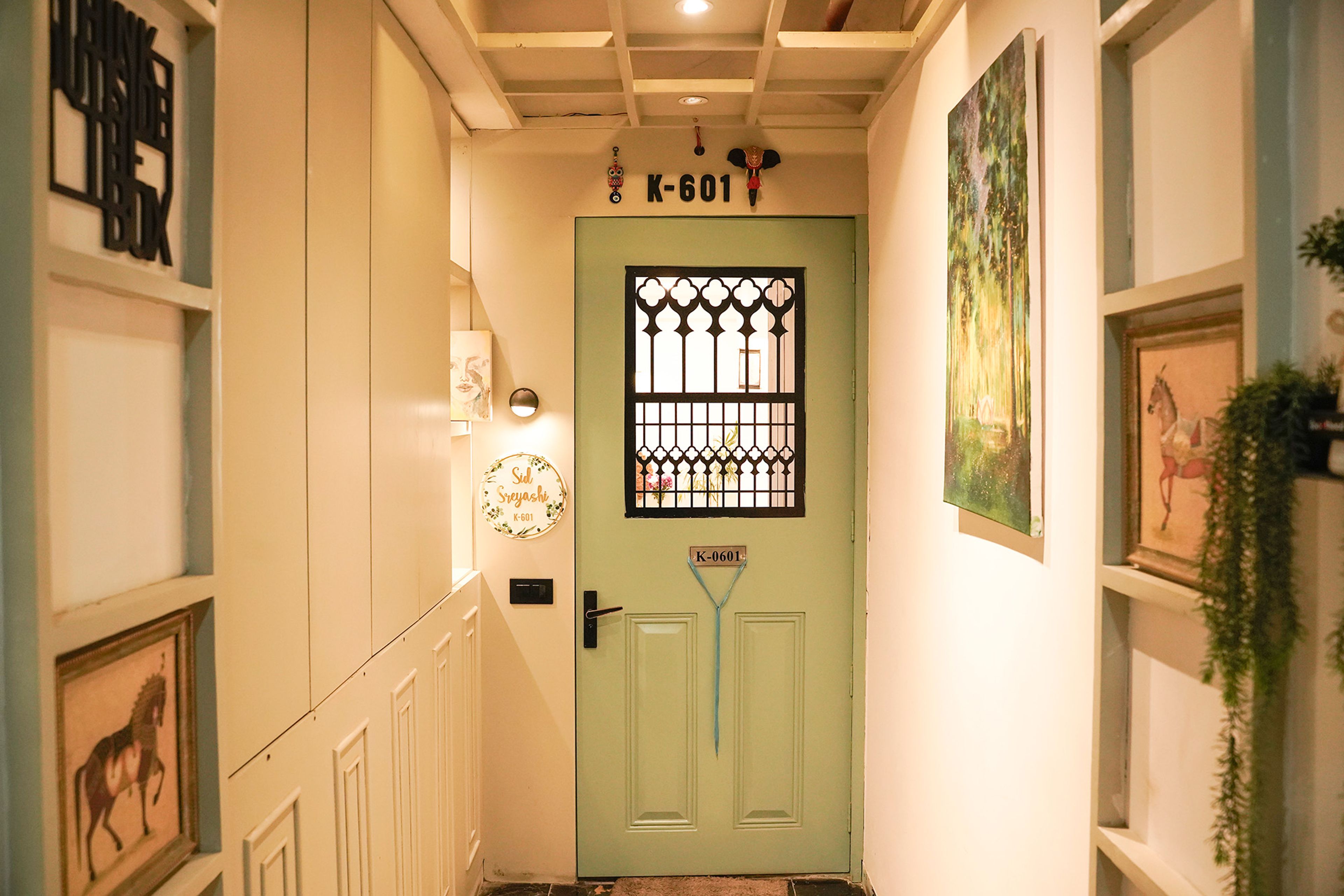 Foyer Design with Mint-Green Main Door, Lattice Grill, and Artistic Wall Decor