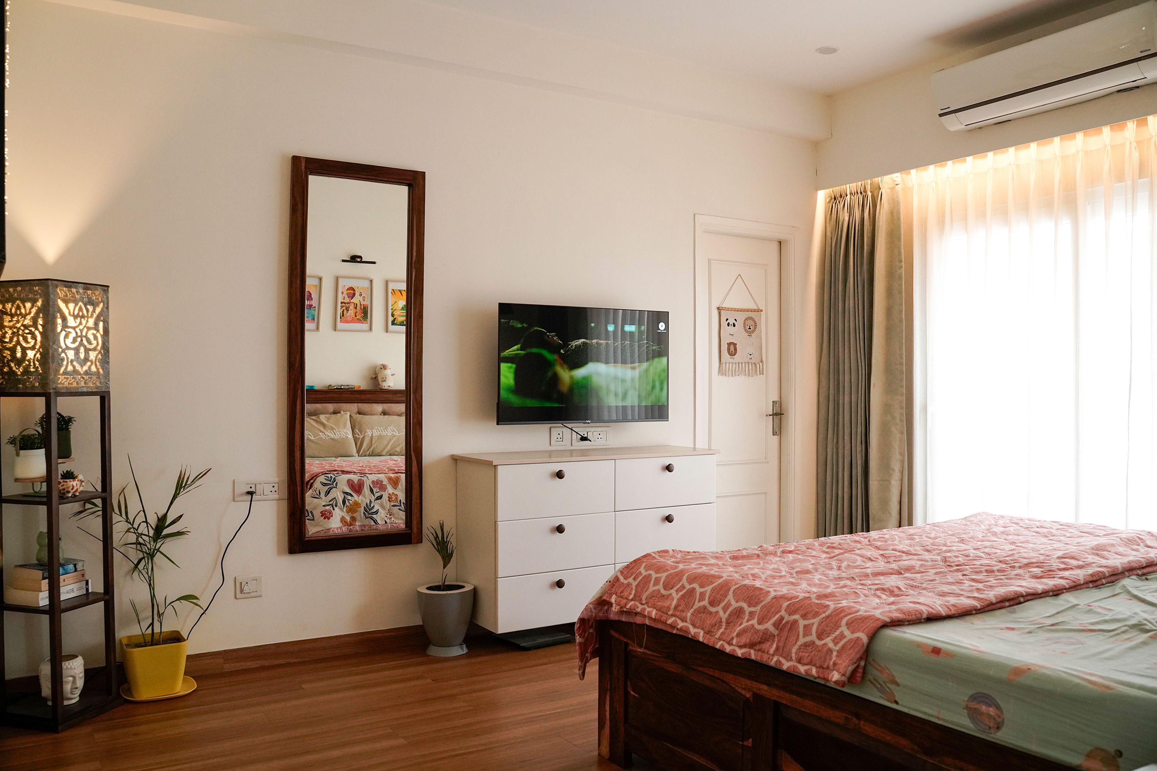Bedroom Design with Wall-Mounted TV Unit, Full-Length Mirror, and White Six-Drawer Dresser