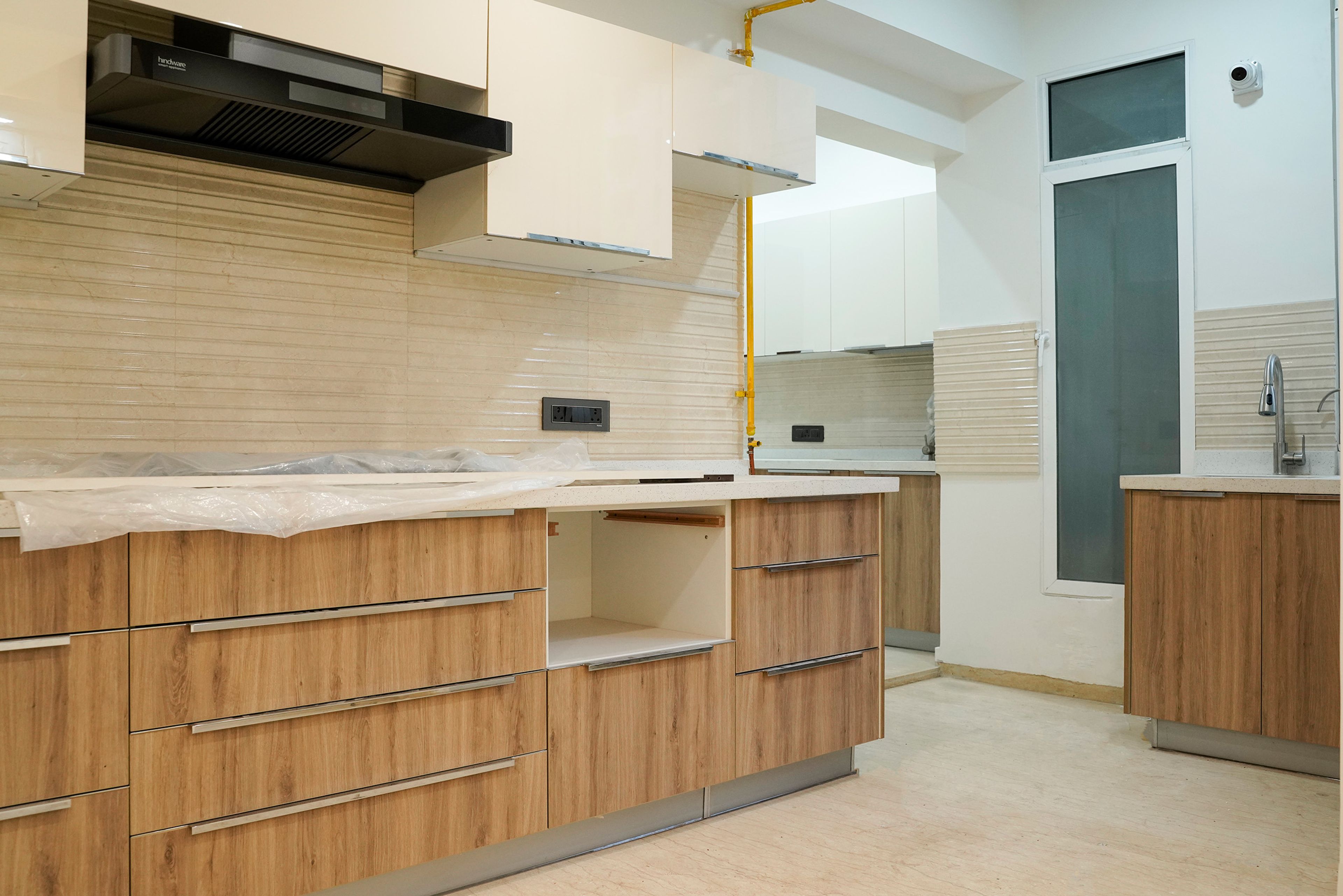L-shaped kitchen design with wooden base units
