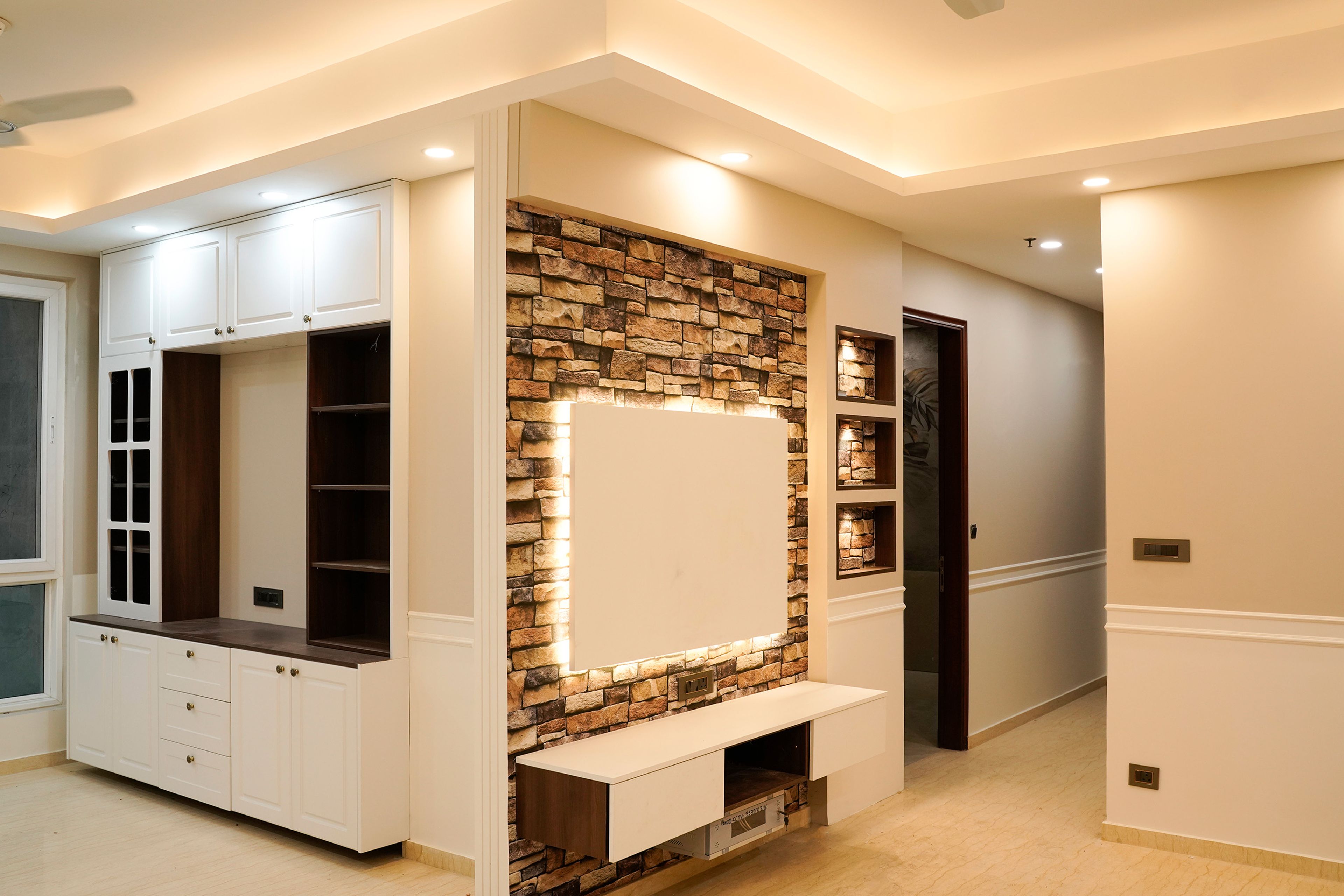 TV unit design with brick textured wall and white crockery unit