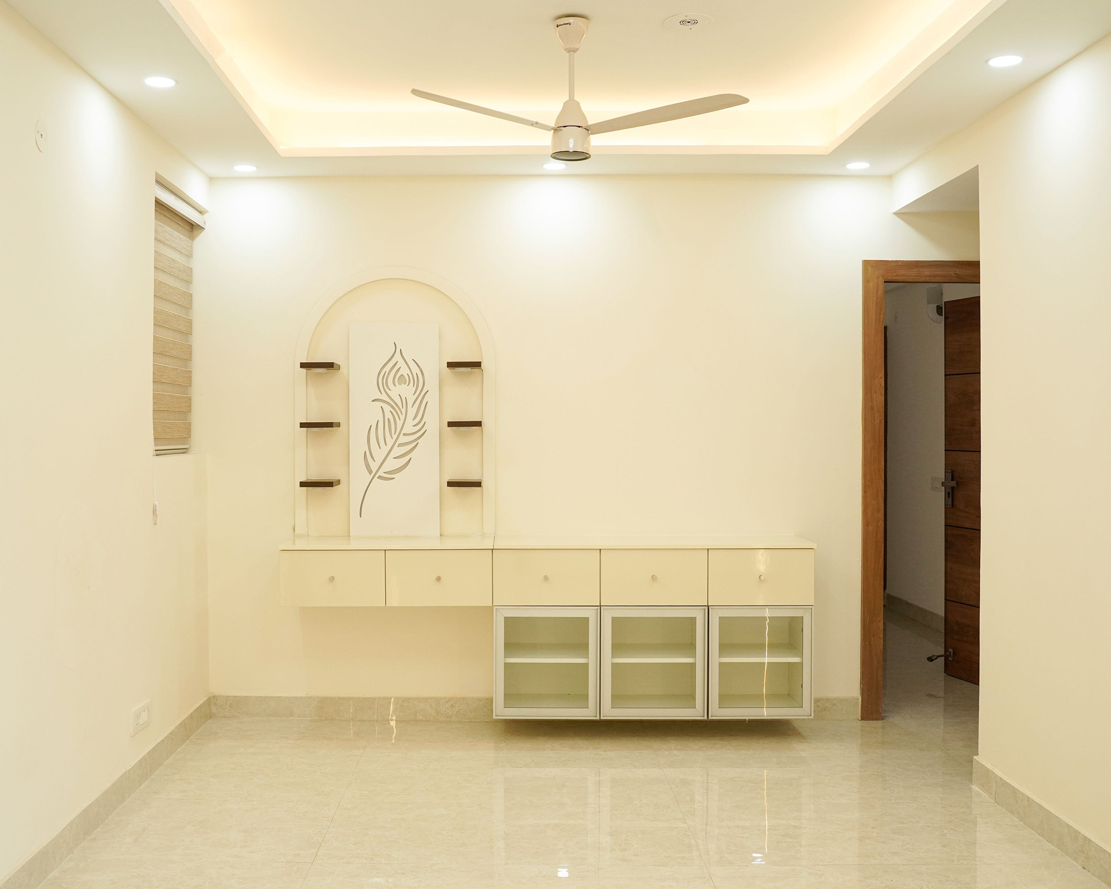 Living Room Design with Off-White Wall Mounted TV Unit and Pooja Space with Peacock Leaf CNC Cut