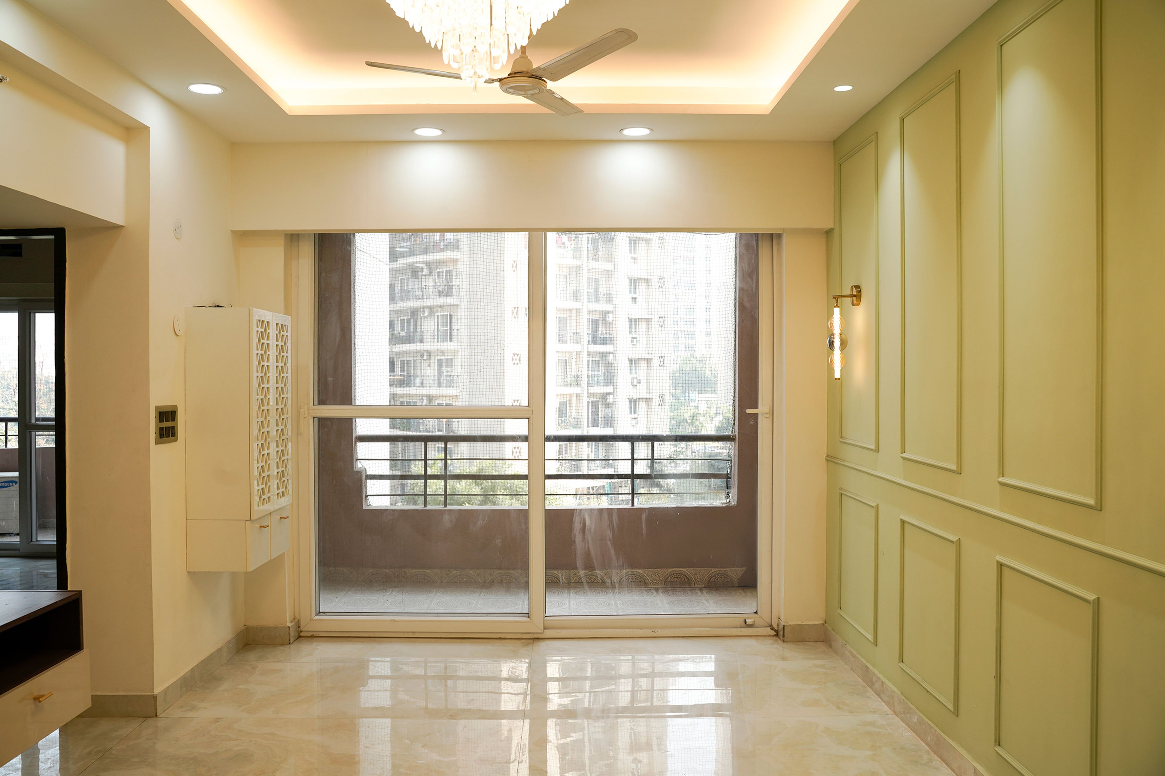 Living Room Design with Pista Green Wall with Trims and White Pooja Unit