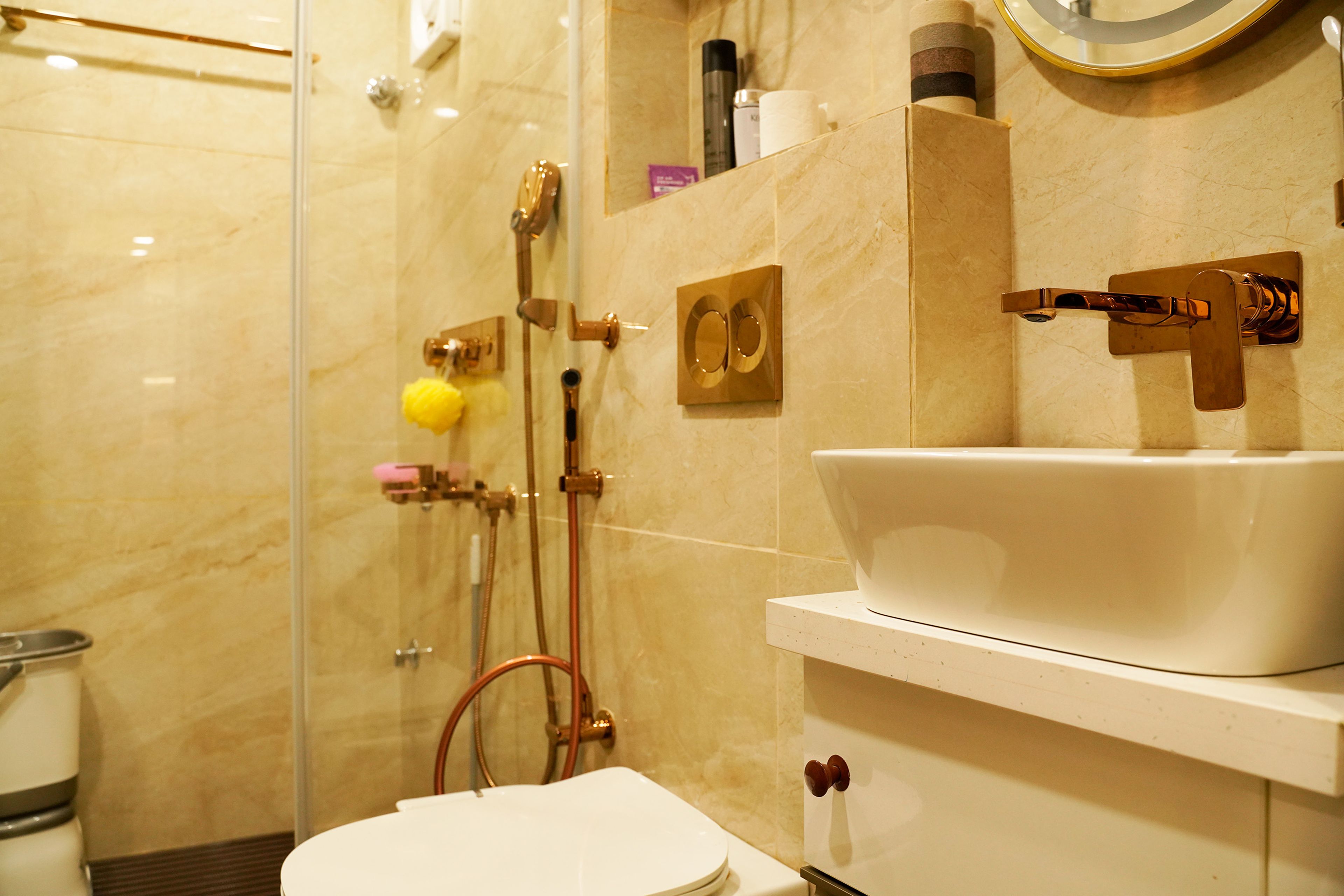 Bathroom Design with Light Brown Marble Patterned Wall and Golden Fixtures