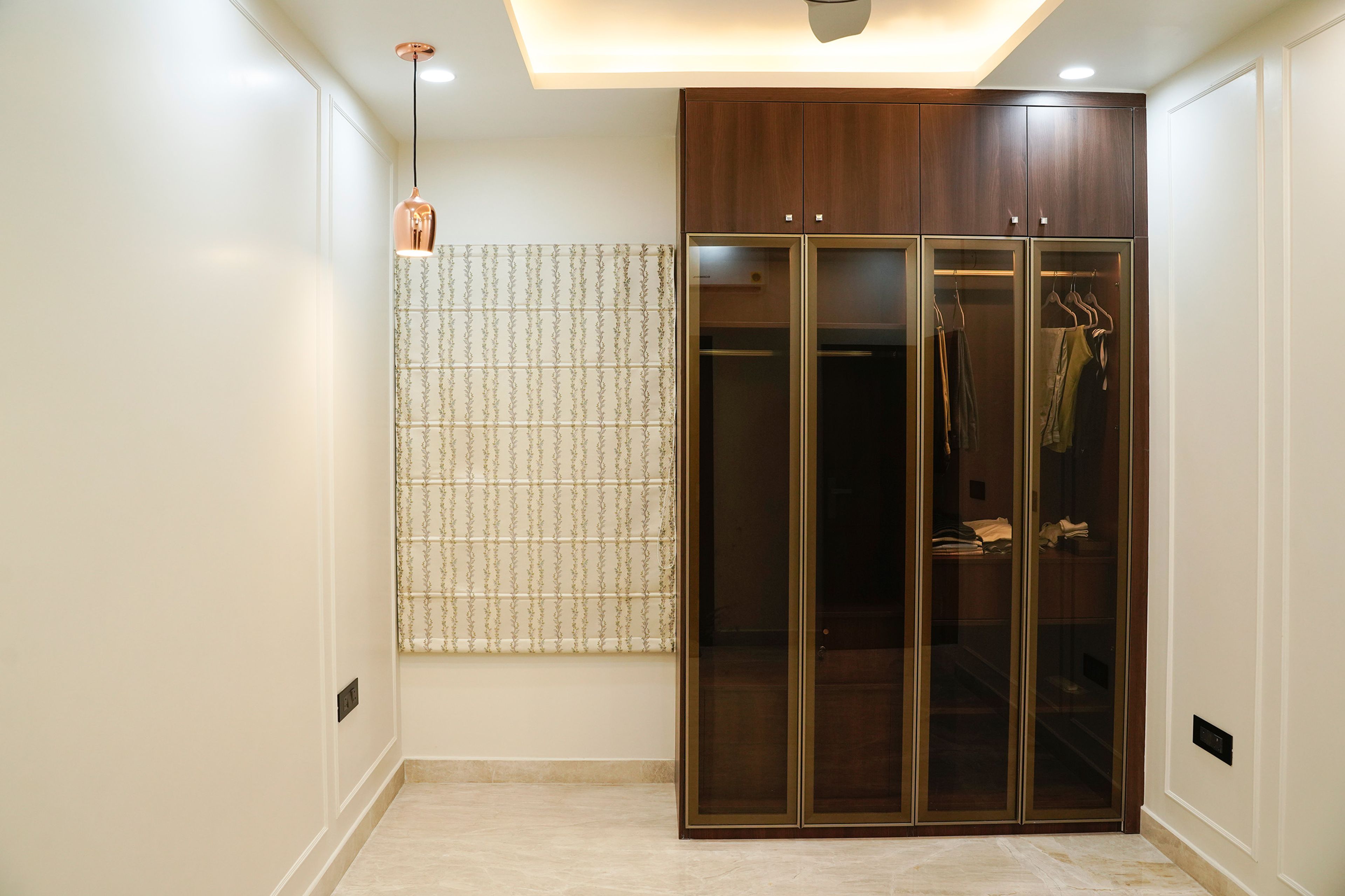 4-Door Swing Wardrobe Design with Glass Shutters and Loft Unit