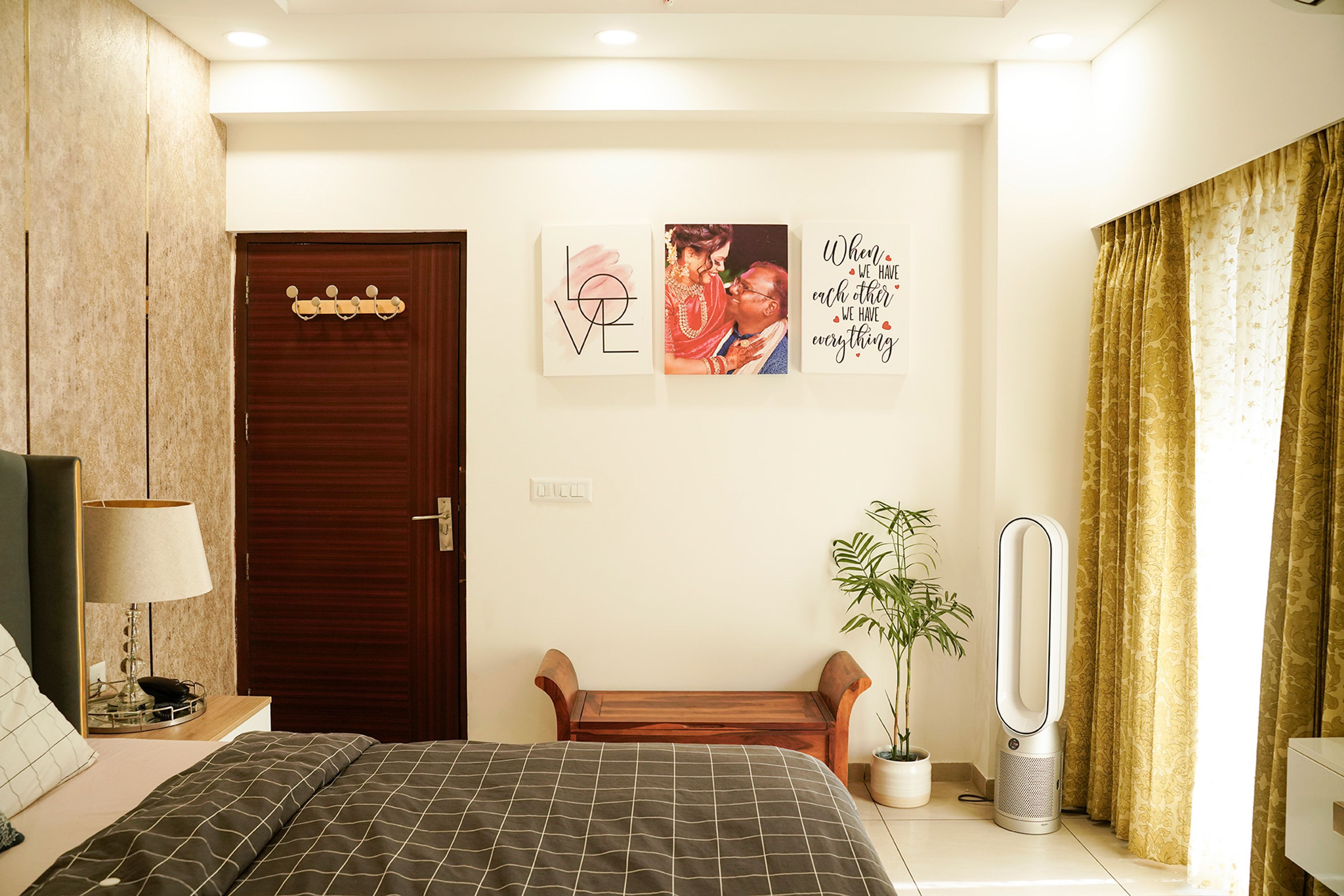 Bedroom Design with Wooden Bench and White Wall with Family Portraits