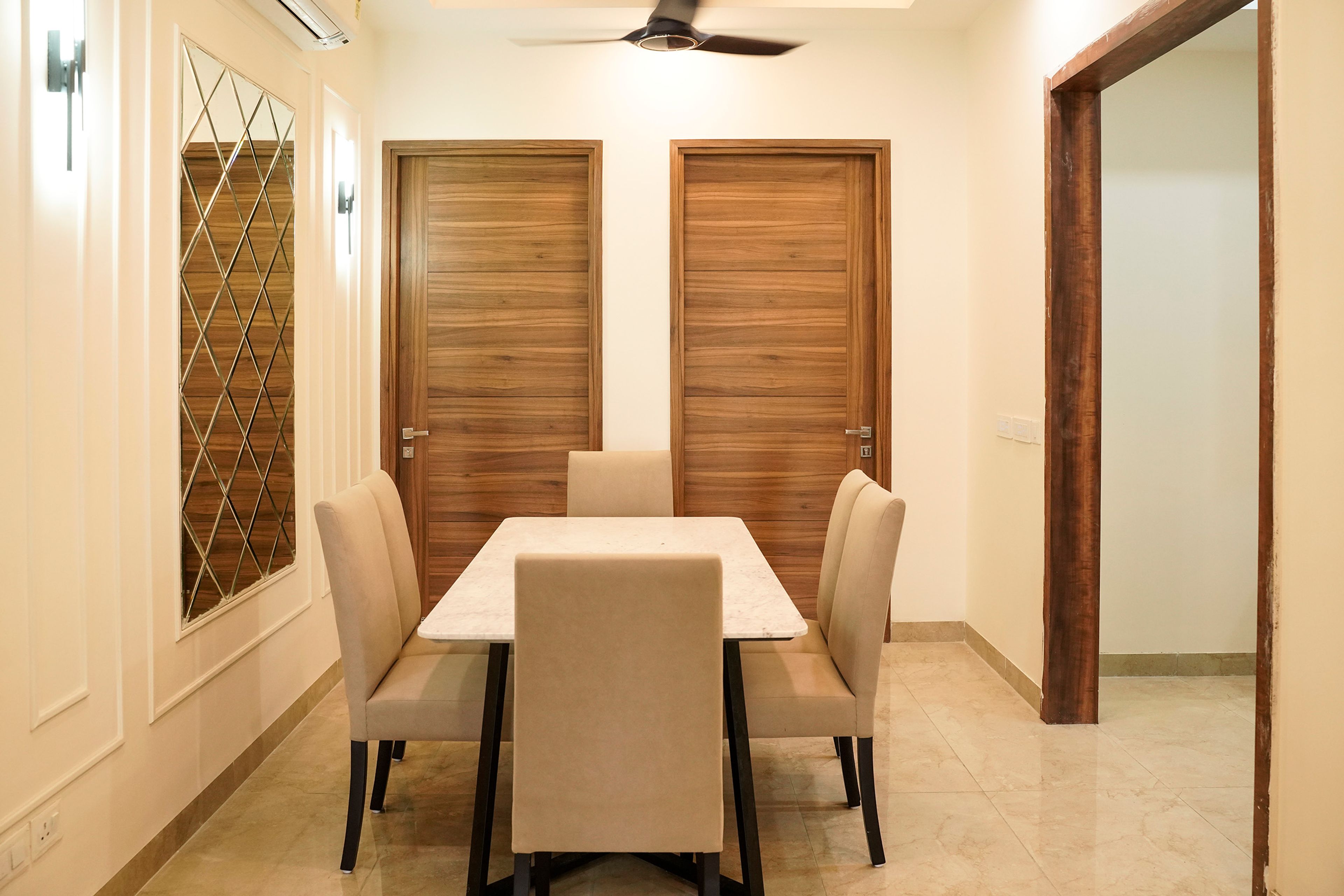 Dining Room Design with Mirrored Wall and 6 Cream Upholstered Chairs