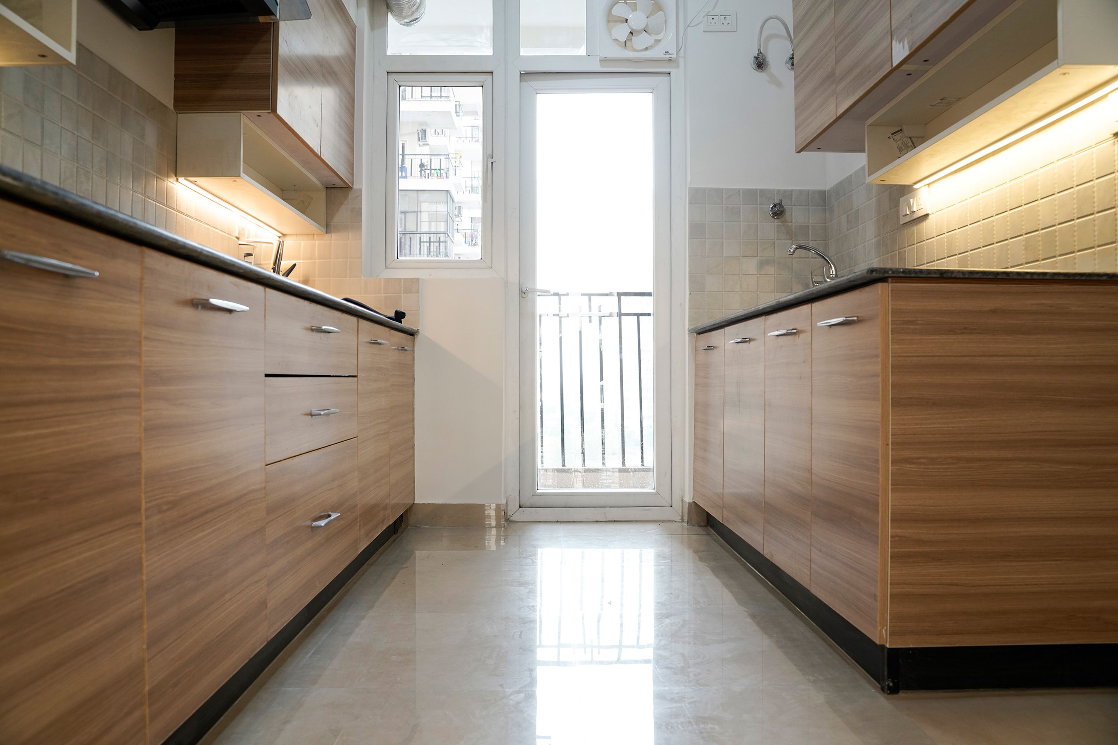 Parallel Kitchen Design with Wooden Base units and Under Cabinet Lighting