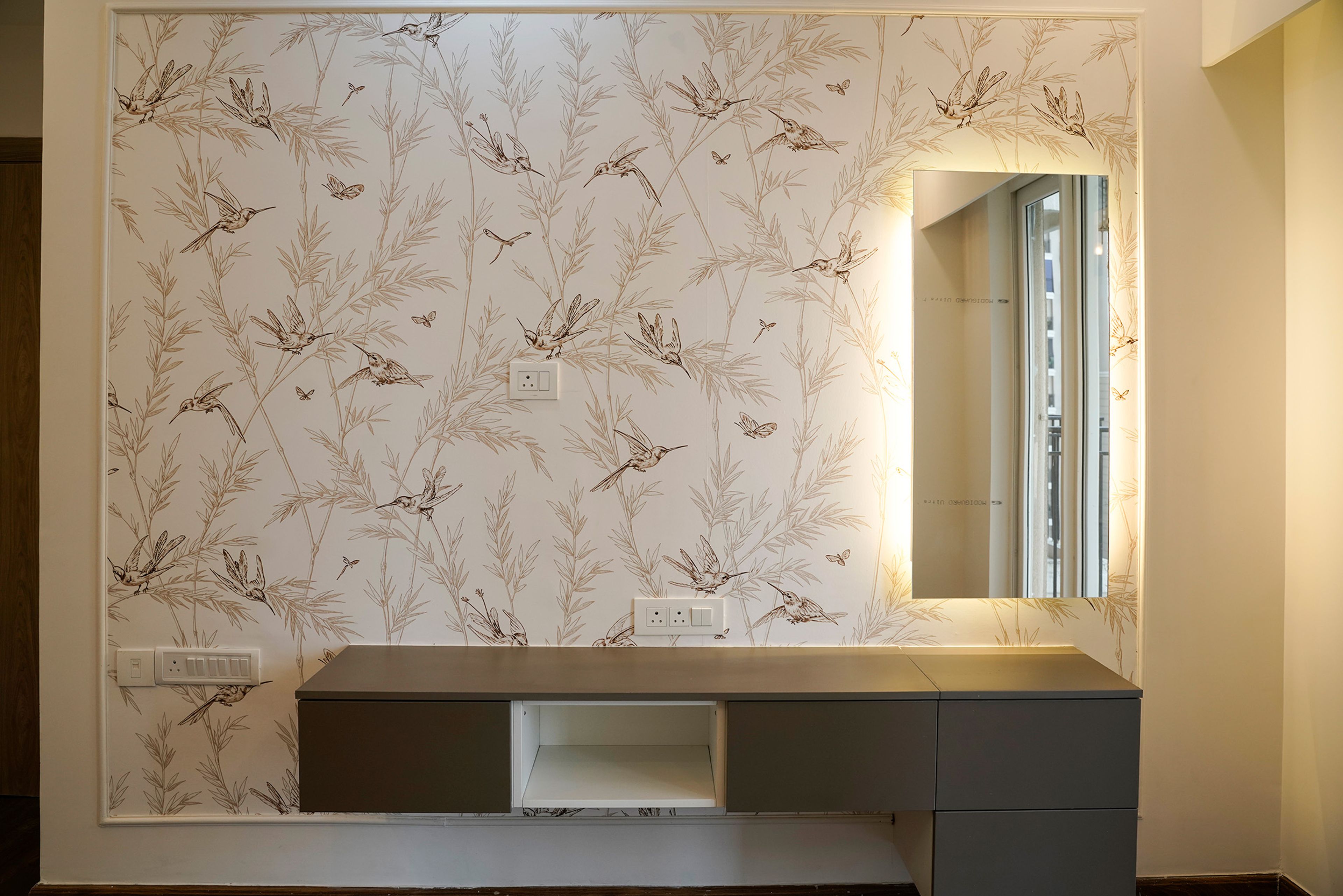 TV Unit Design with Brown Drawers and Leaves and Bird Pattern Wallpaper