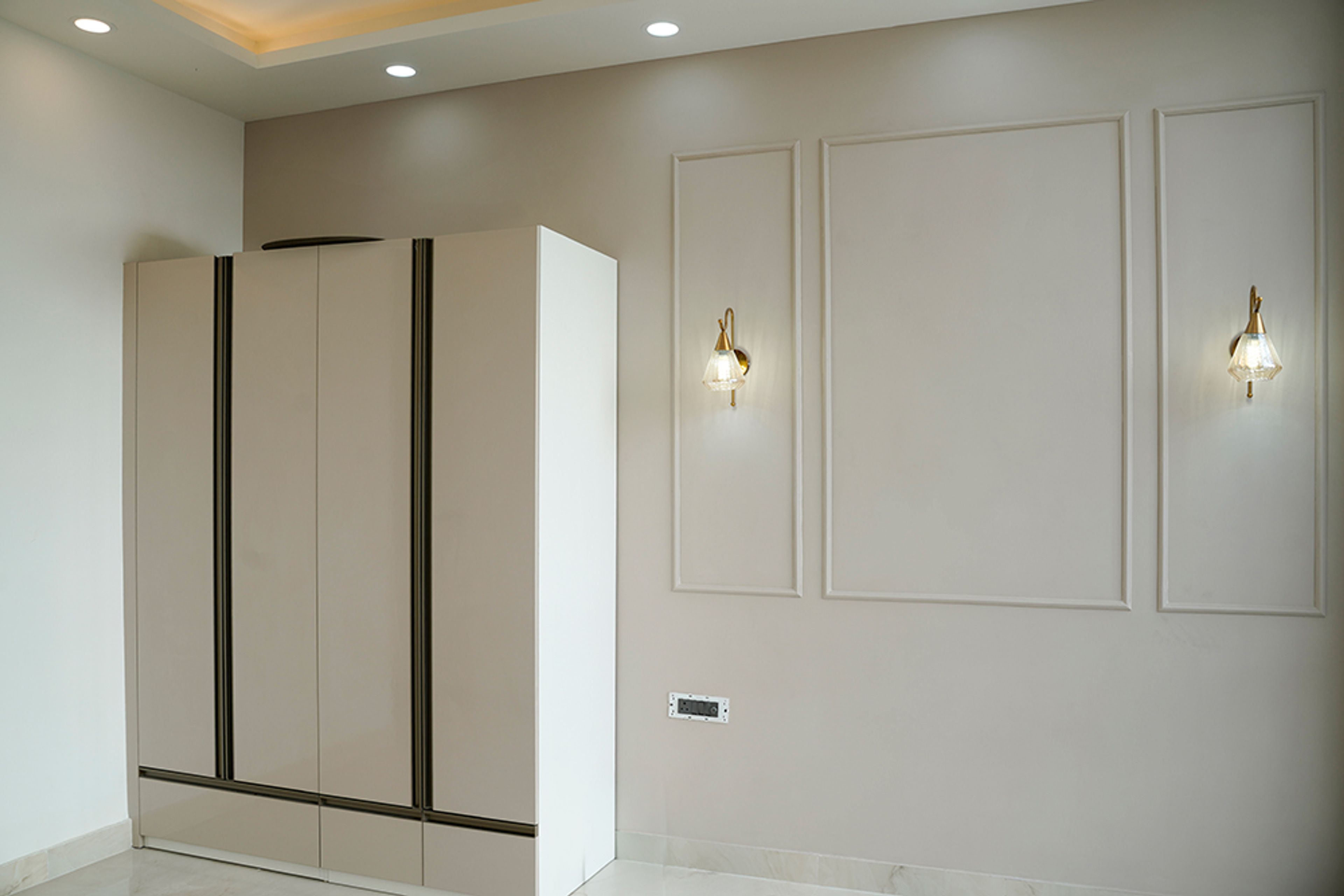 Beige Wall Design with Trims and 4-Door Swing Wardrobe