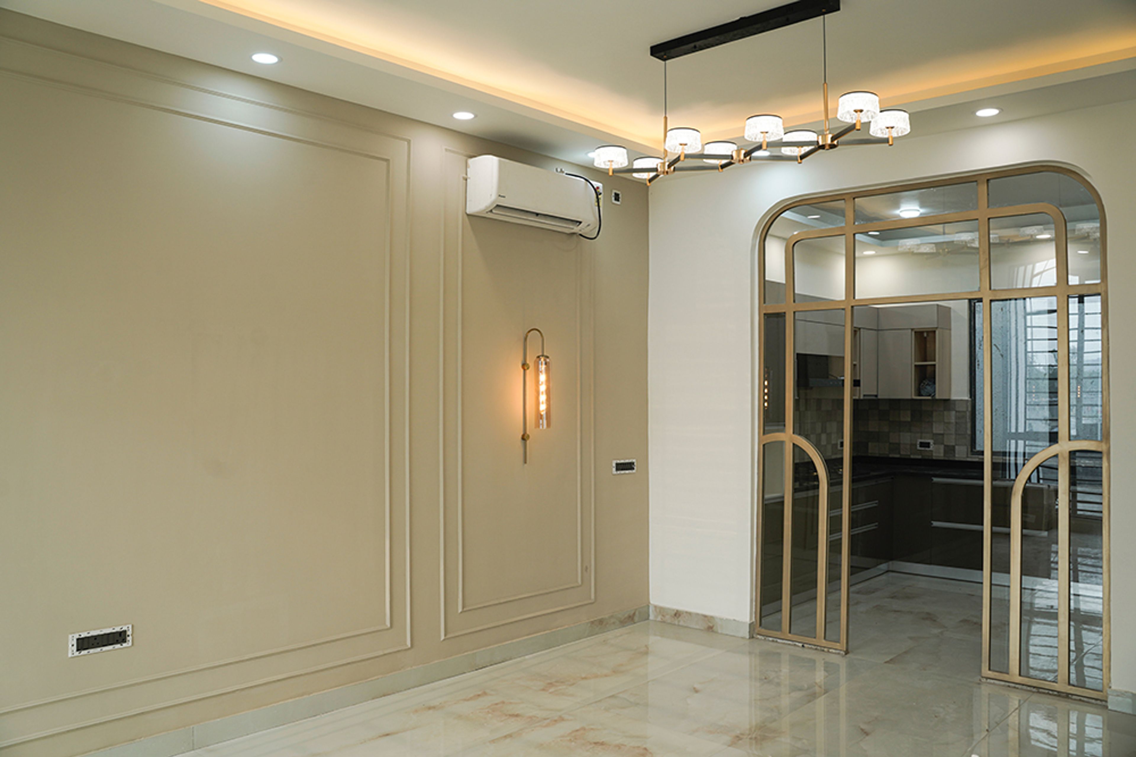 Living Room Design with Light Brown Wall with Trims, Chandelier and False Ceiling