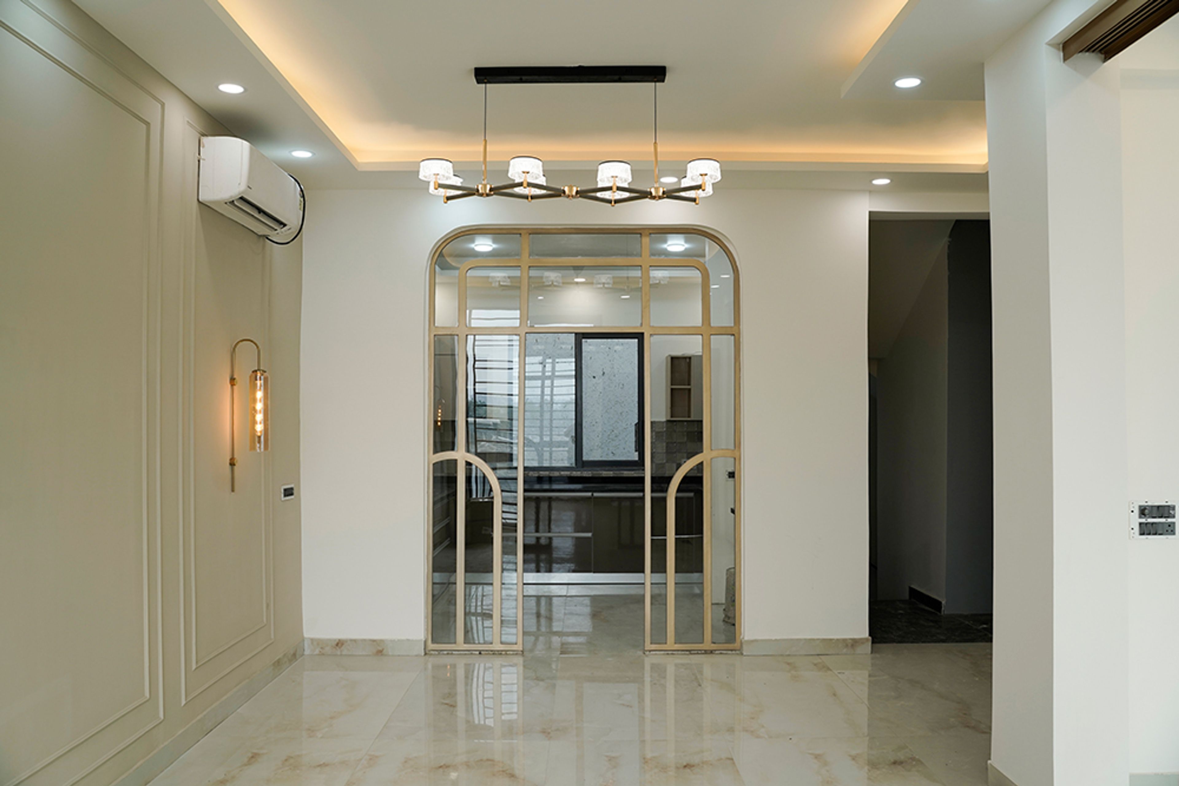 Living Room Design with Light Brown Walls and Metal Frame Doorway