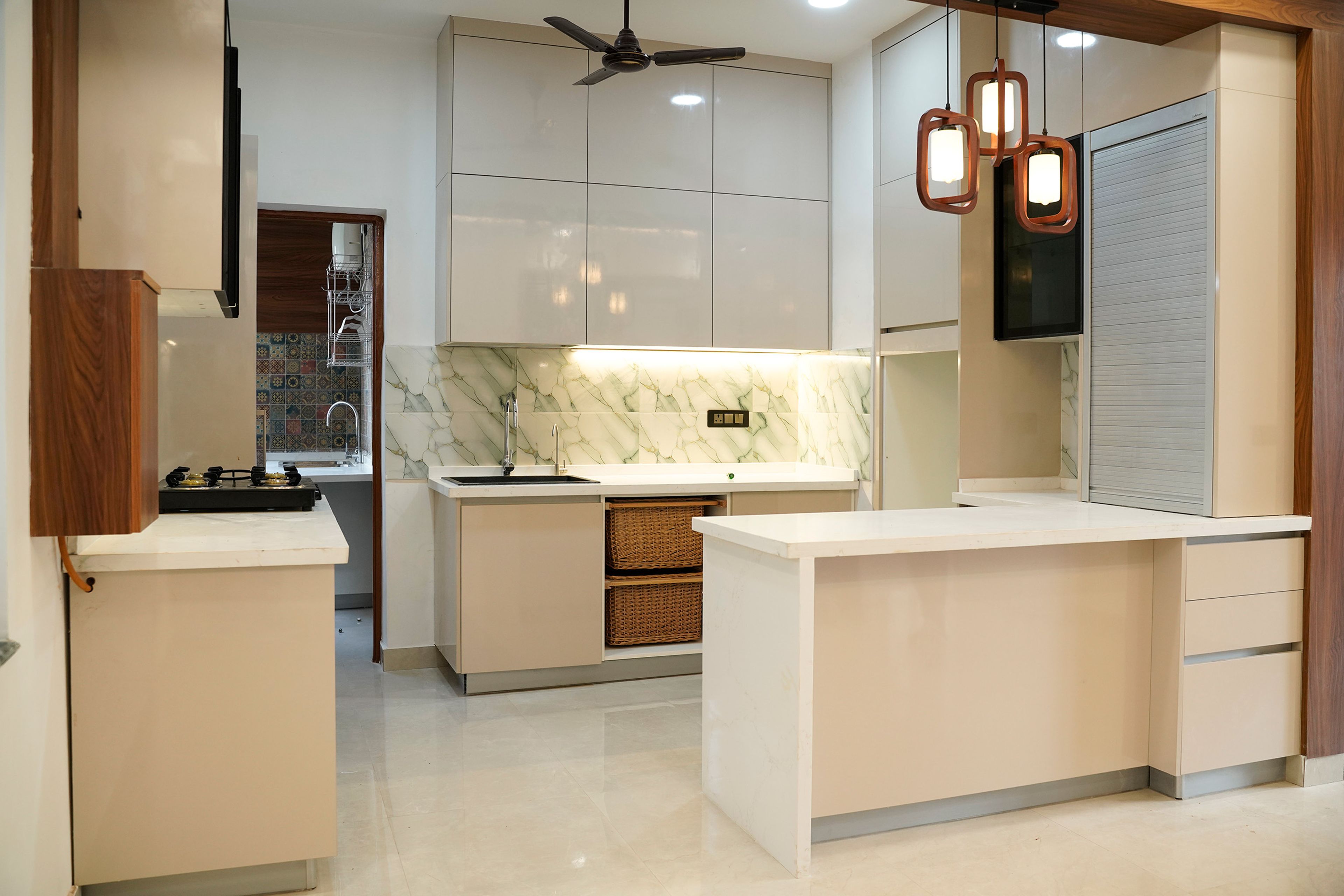 Open Kitchen with White and Cream Units with Wicker Basket