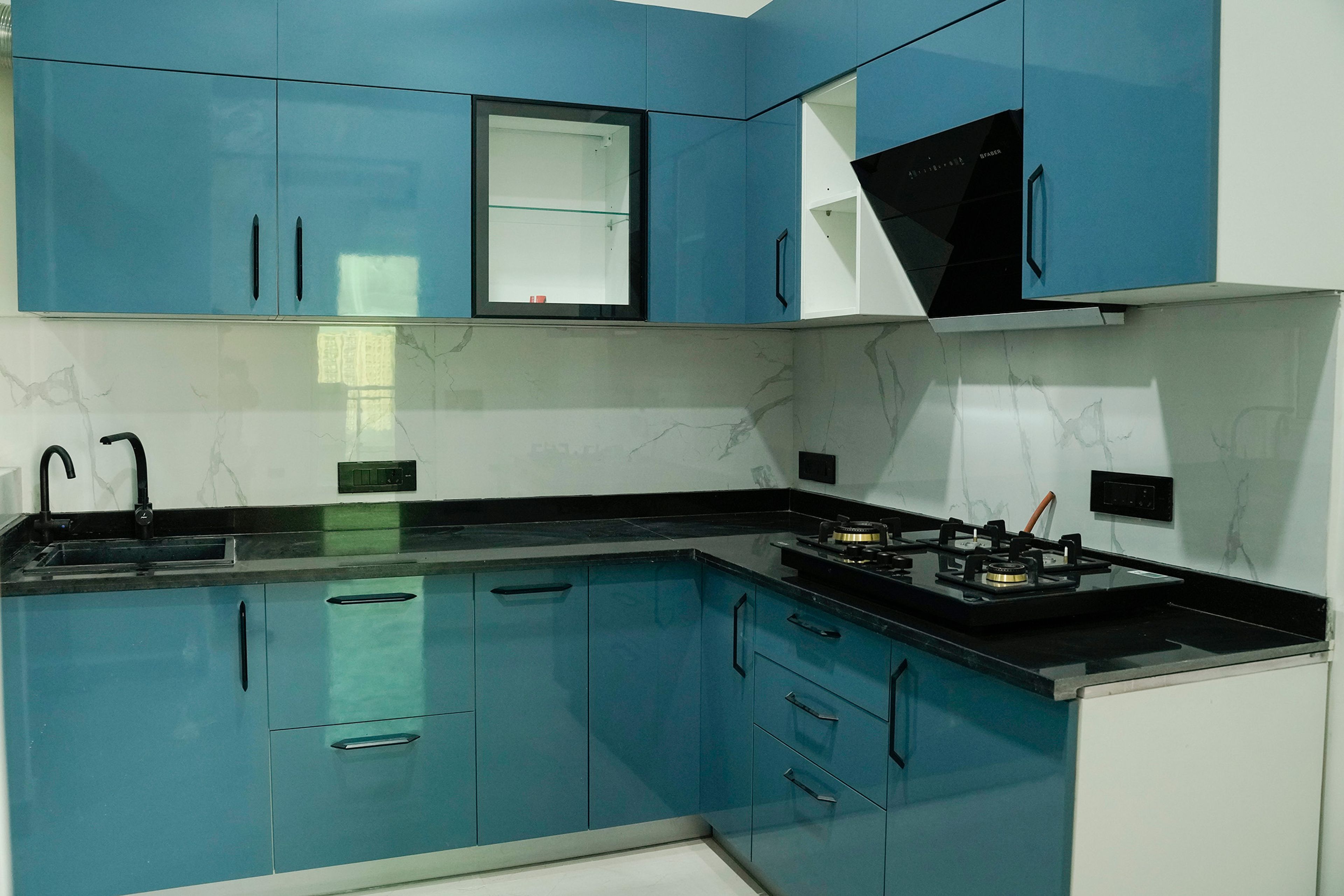 L-shaped kitchen design with blue units