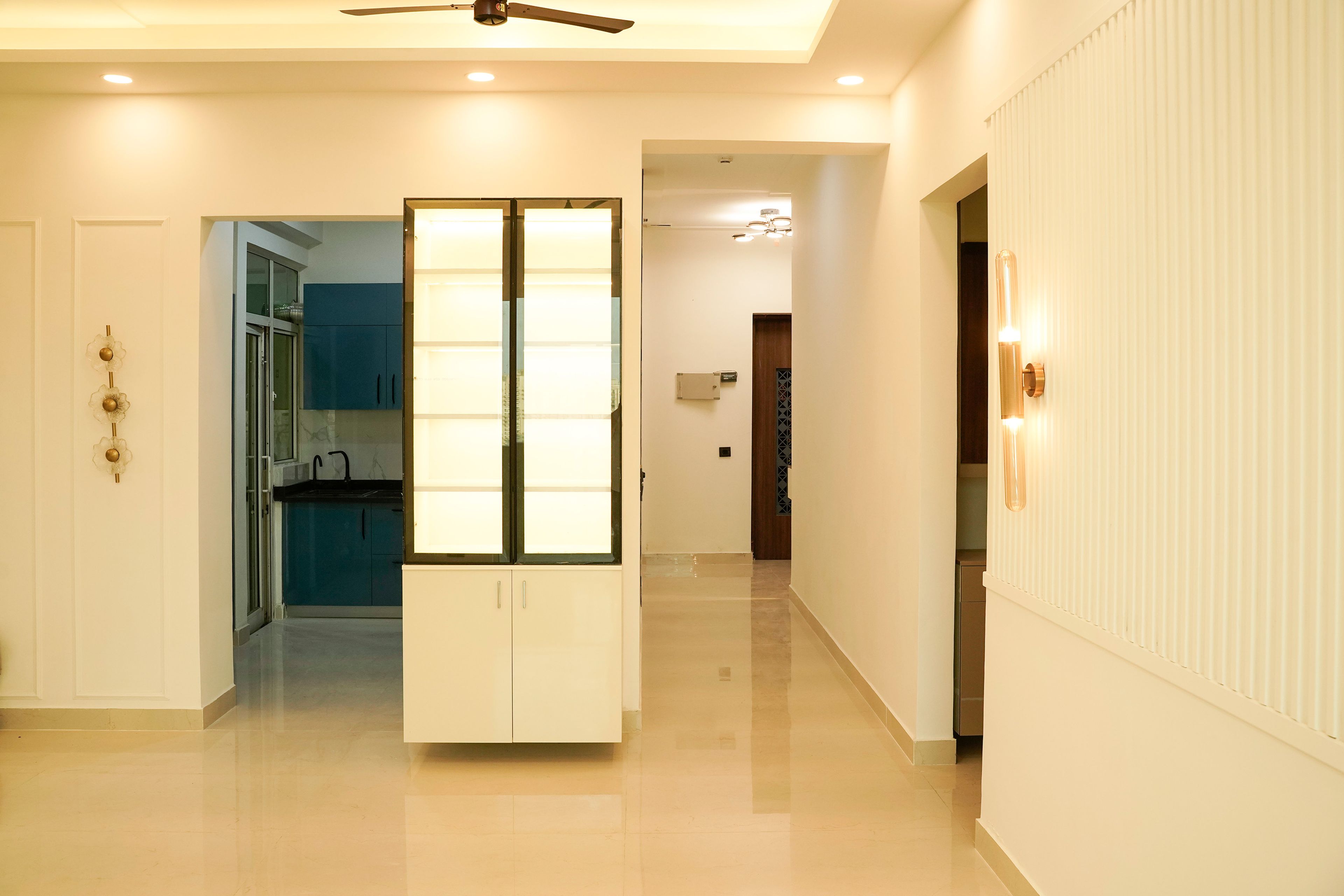 Crockery unit with cream cabinets and warm lighting
