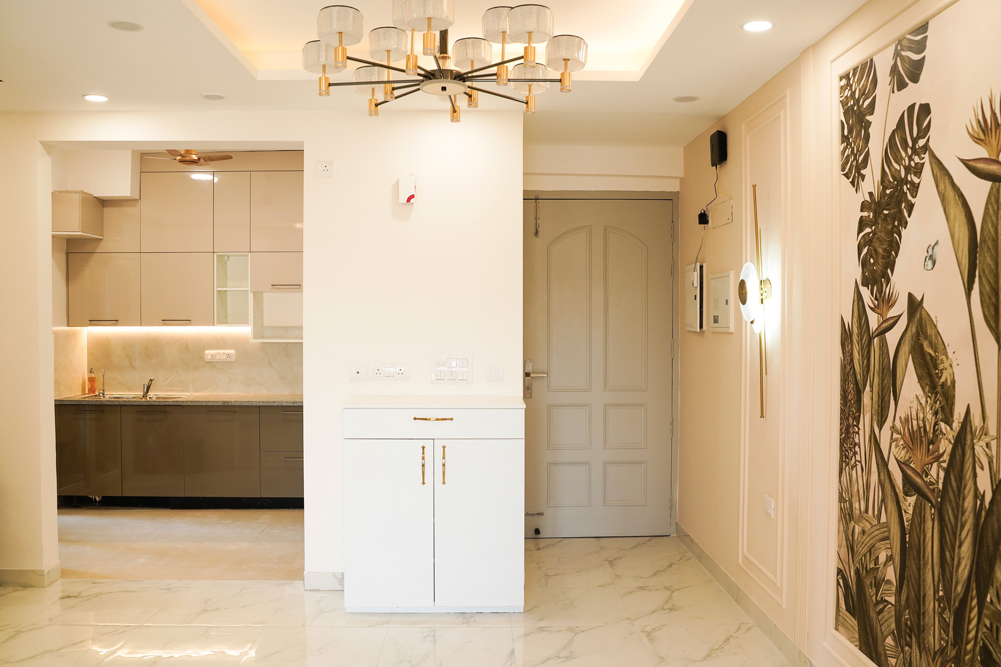 Foyer Design with White Shoe Cabinet and Tropical Themed Wall