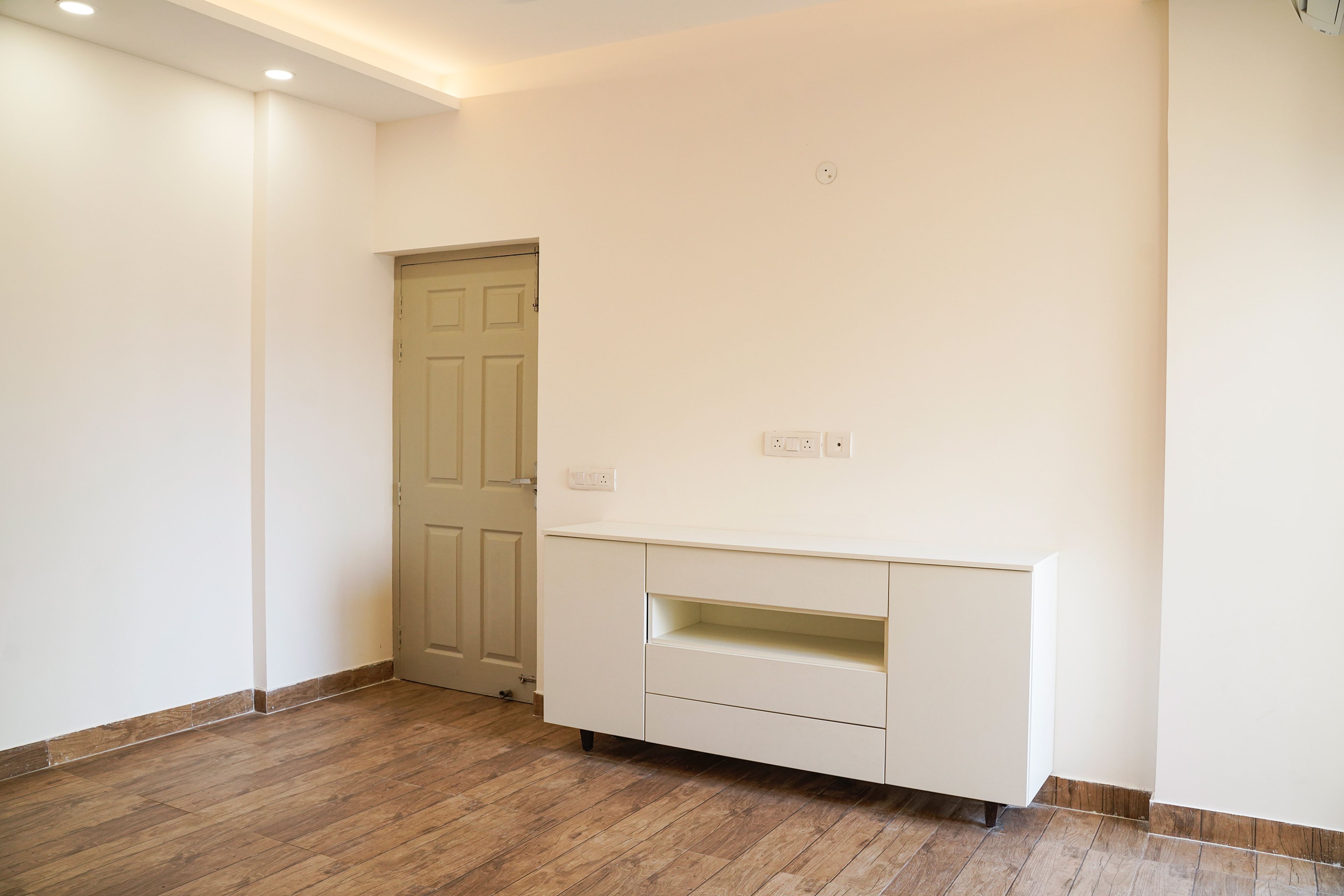 Off-White Wall Design with TV Unit Cabinet