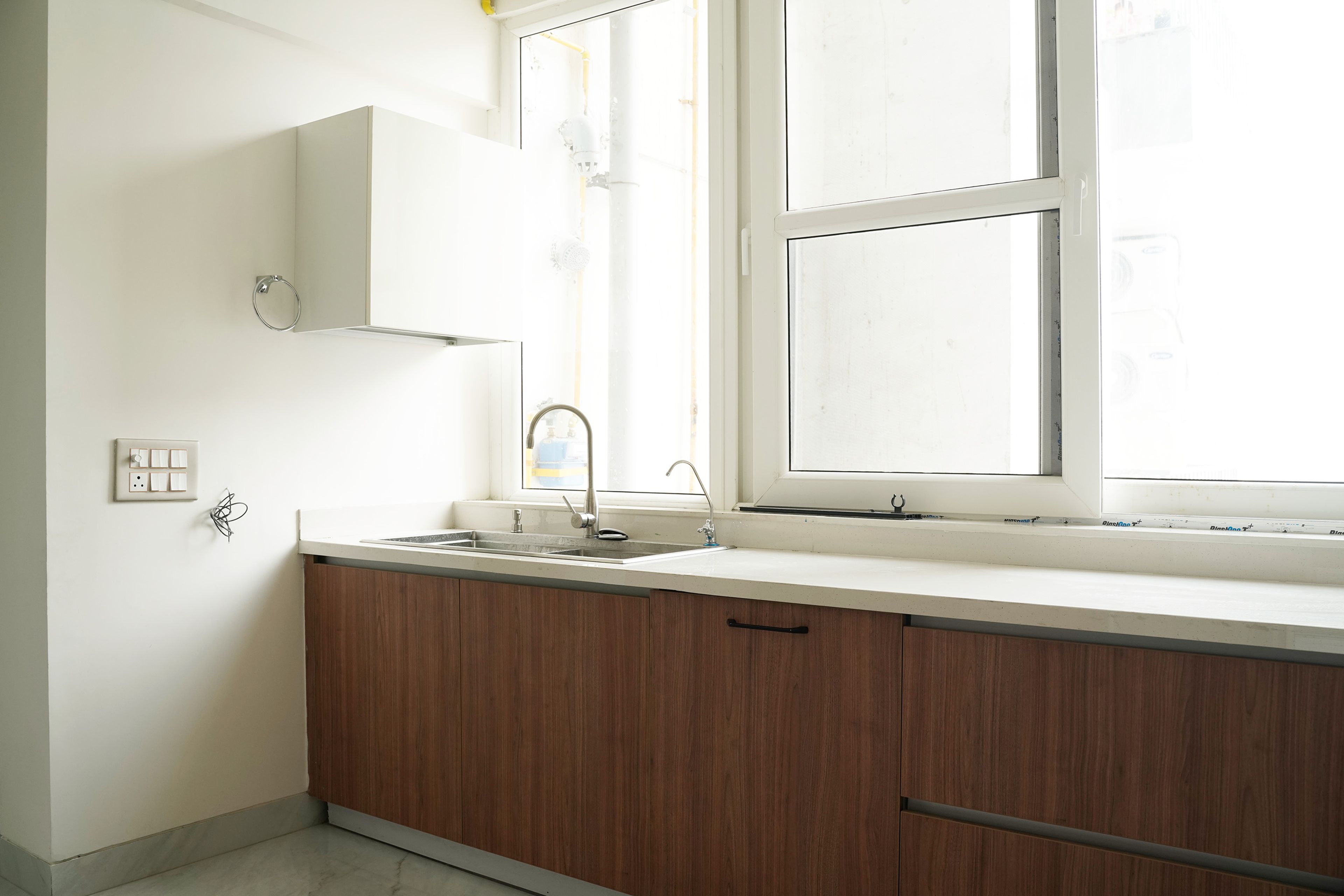 U-Shaped Kitchen Design with White Quartz Countertop and Wooden Units