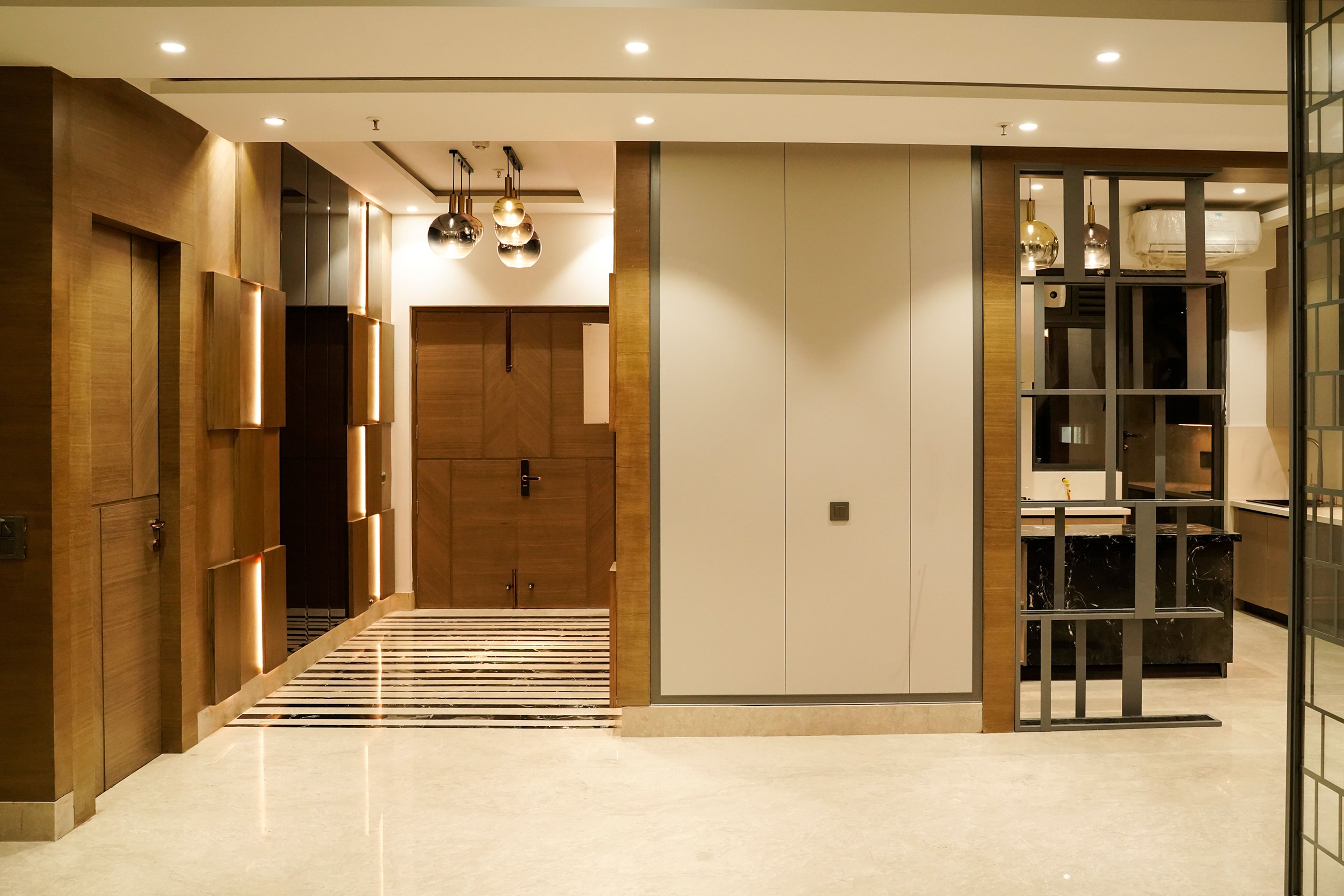 Foyer Design with Wooden Door and Chandelier Lighting