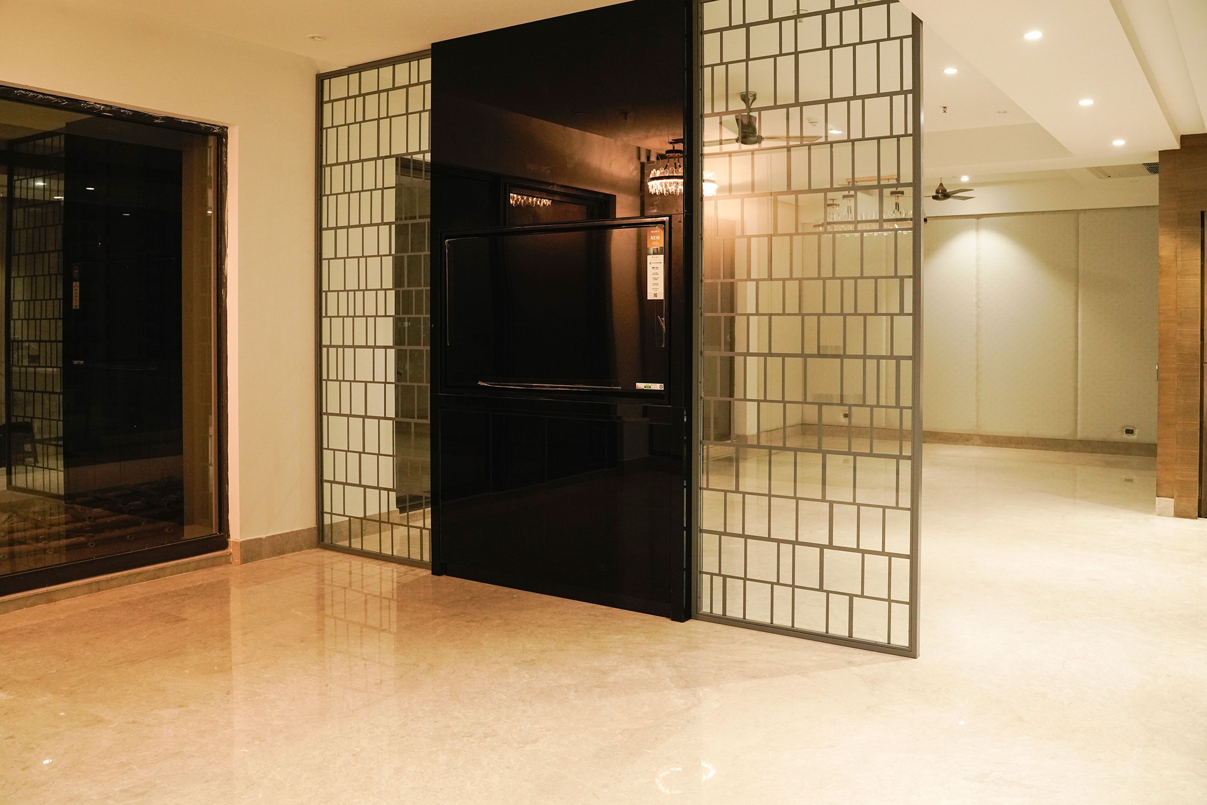 Black TV Unit Design with Attached Geometric Grey Room Dividers