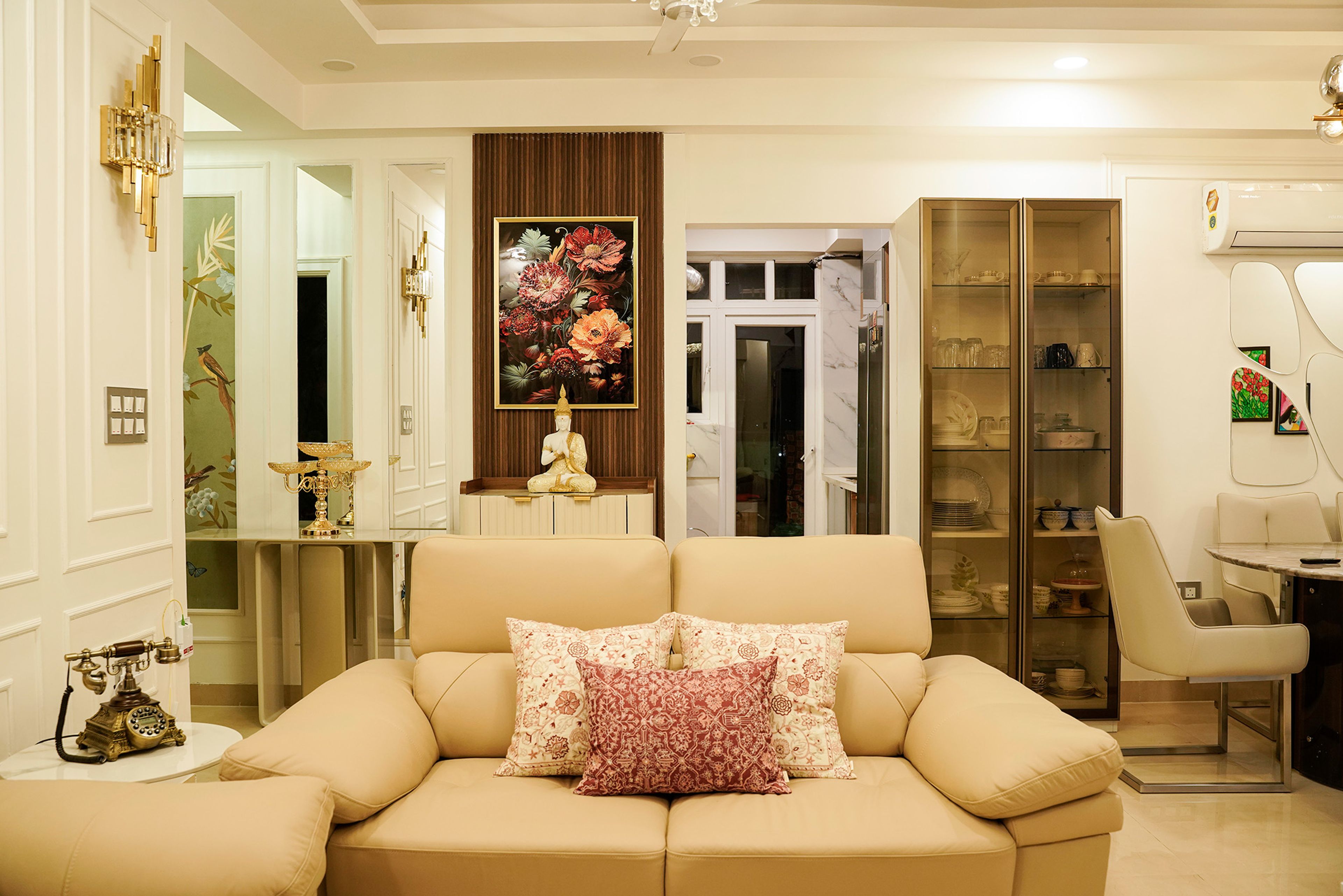 Living Room Design with Beige Sofa and Budhha Idol in the Back with Wooden Panel Wall