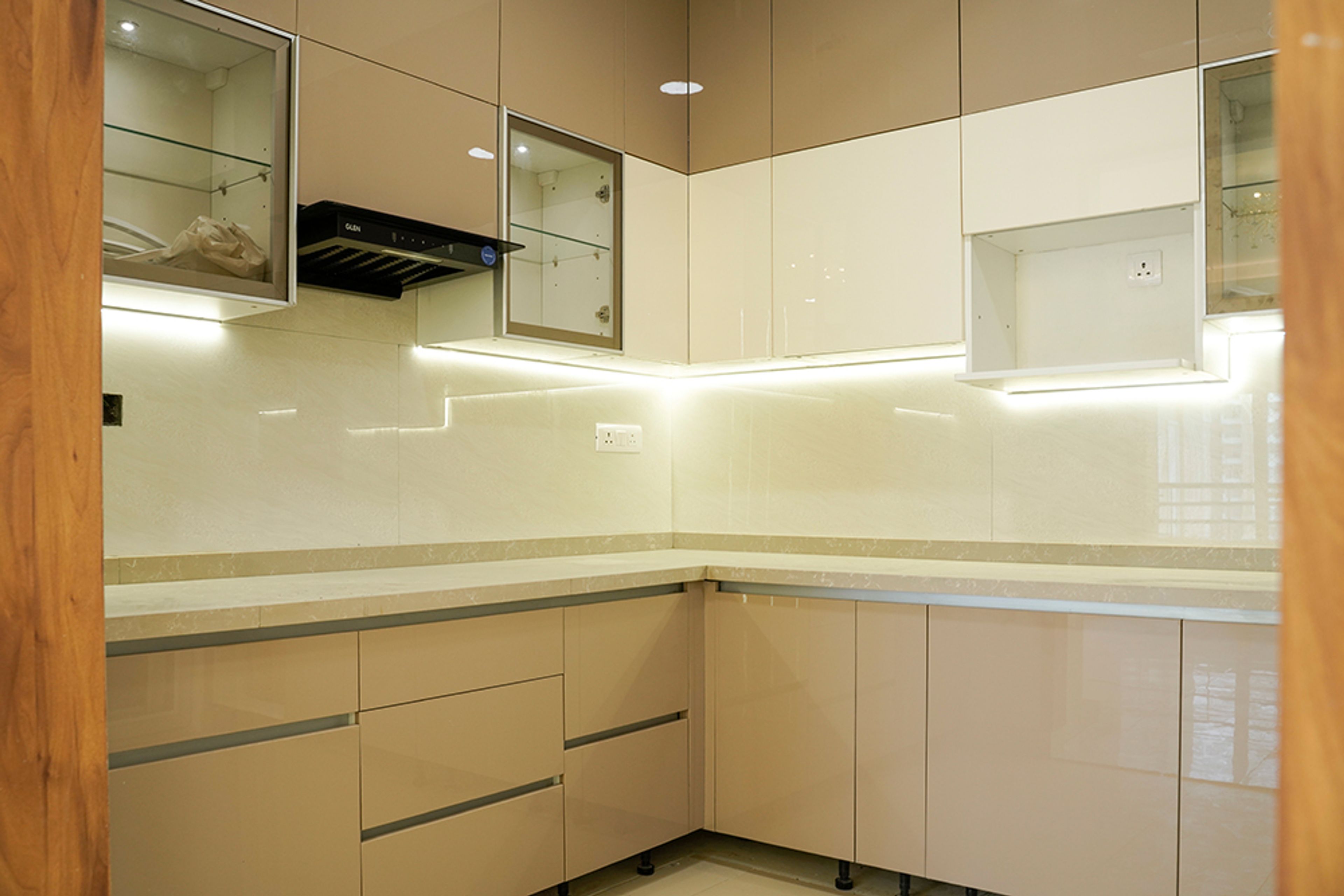 L-Shaped Kitchen Design with Under Cabinet Lighting and White Quartz Countertop