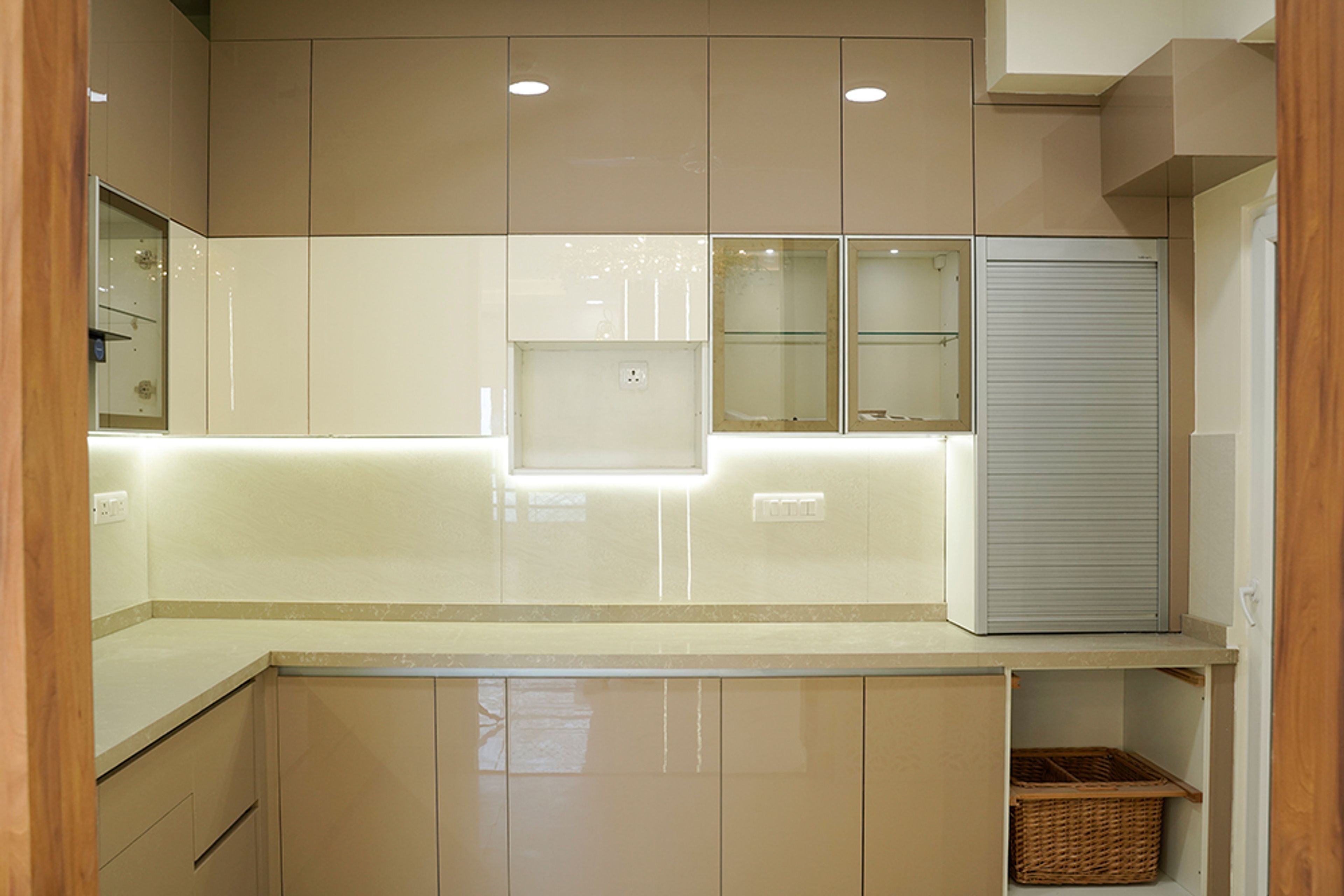 L-Shaped Kitchen Design with Under Cabinet Lighting and White Quartz Countertop