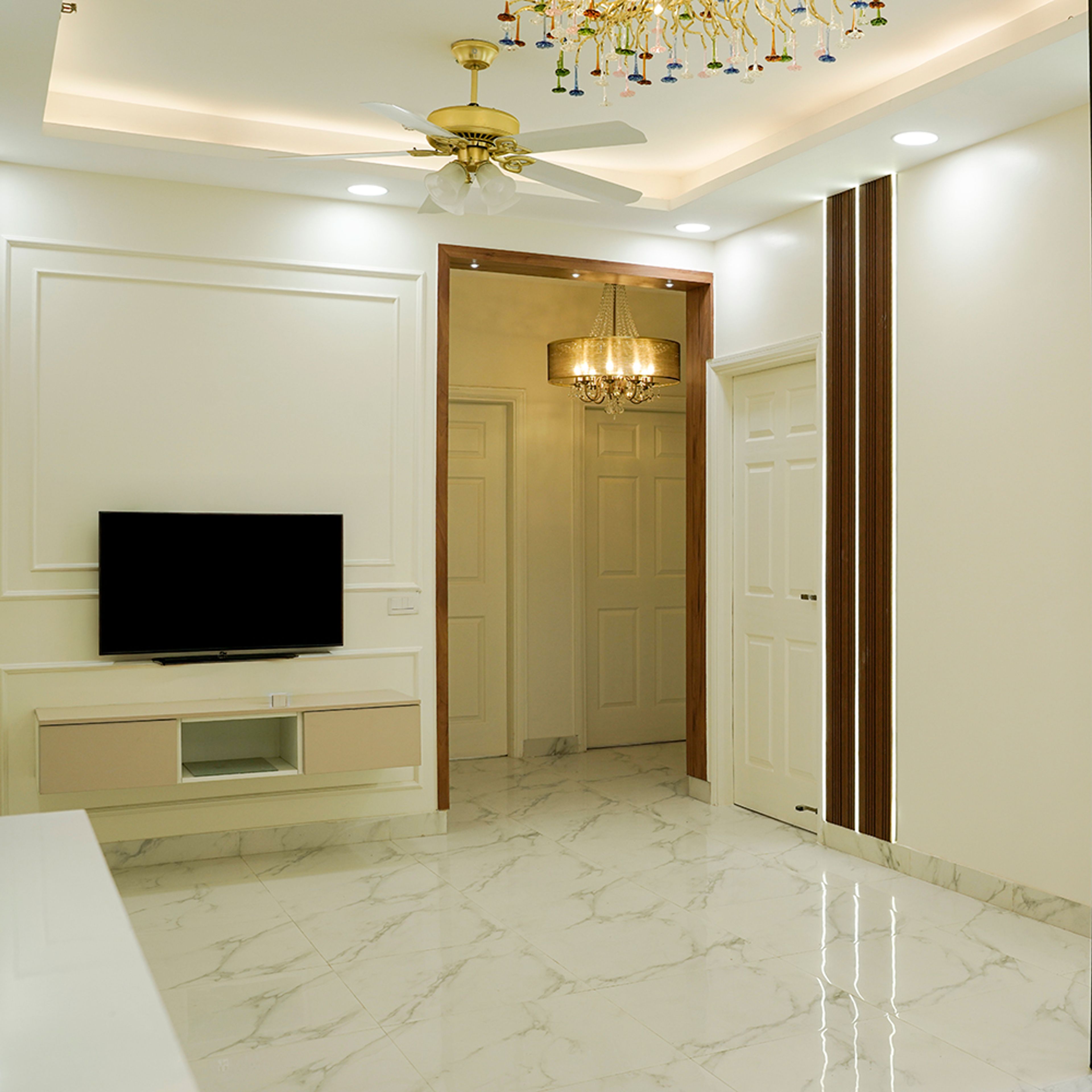 Living Room Design with TV Unit with White Walls with Trims and Beige Drawers