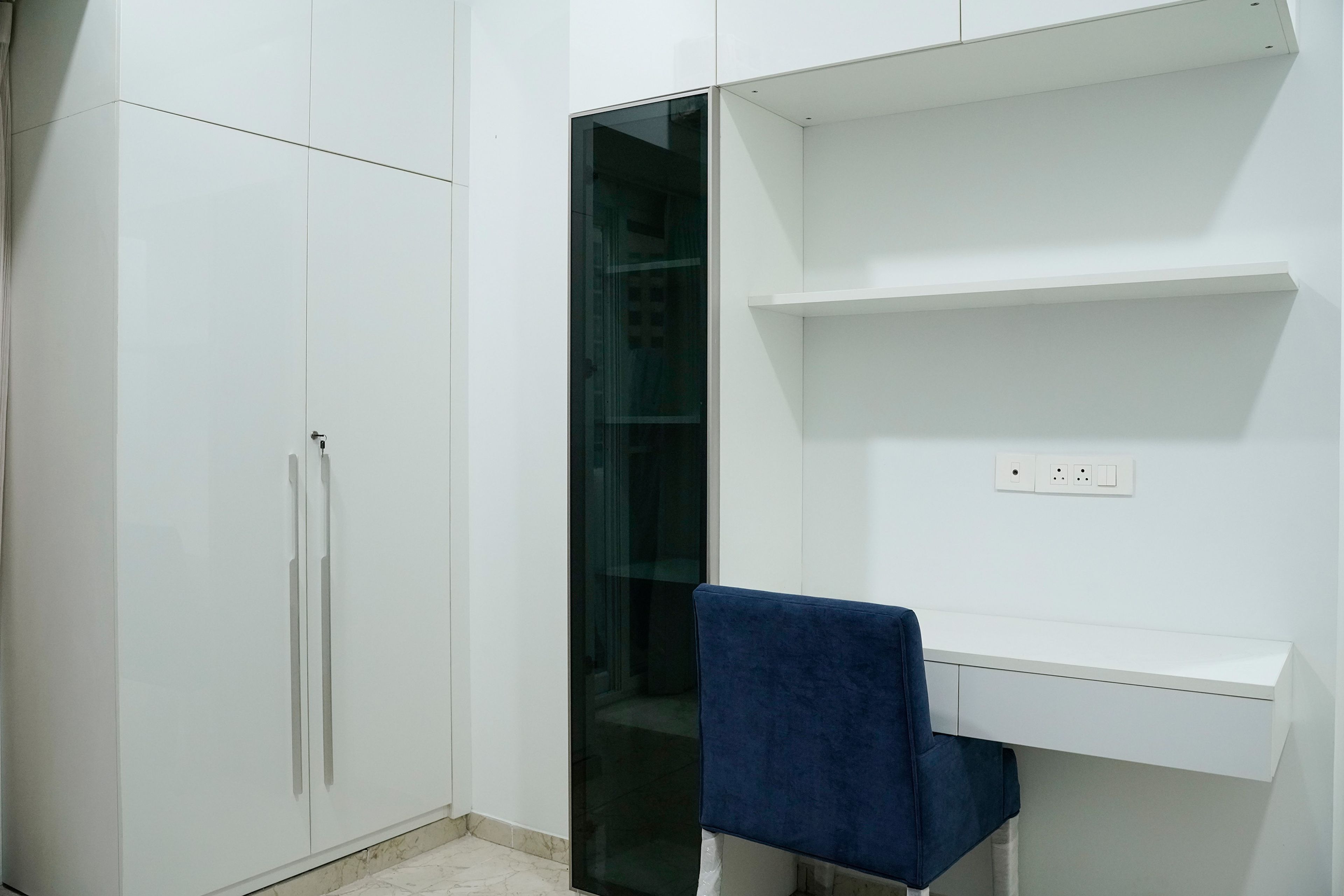 Study Space with White Wall Shelves, Blue Chair, Tall Unit and 2-Door Swing Wardrobe