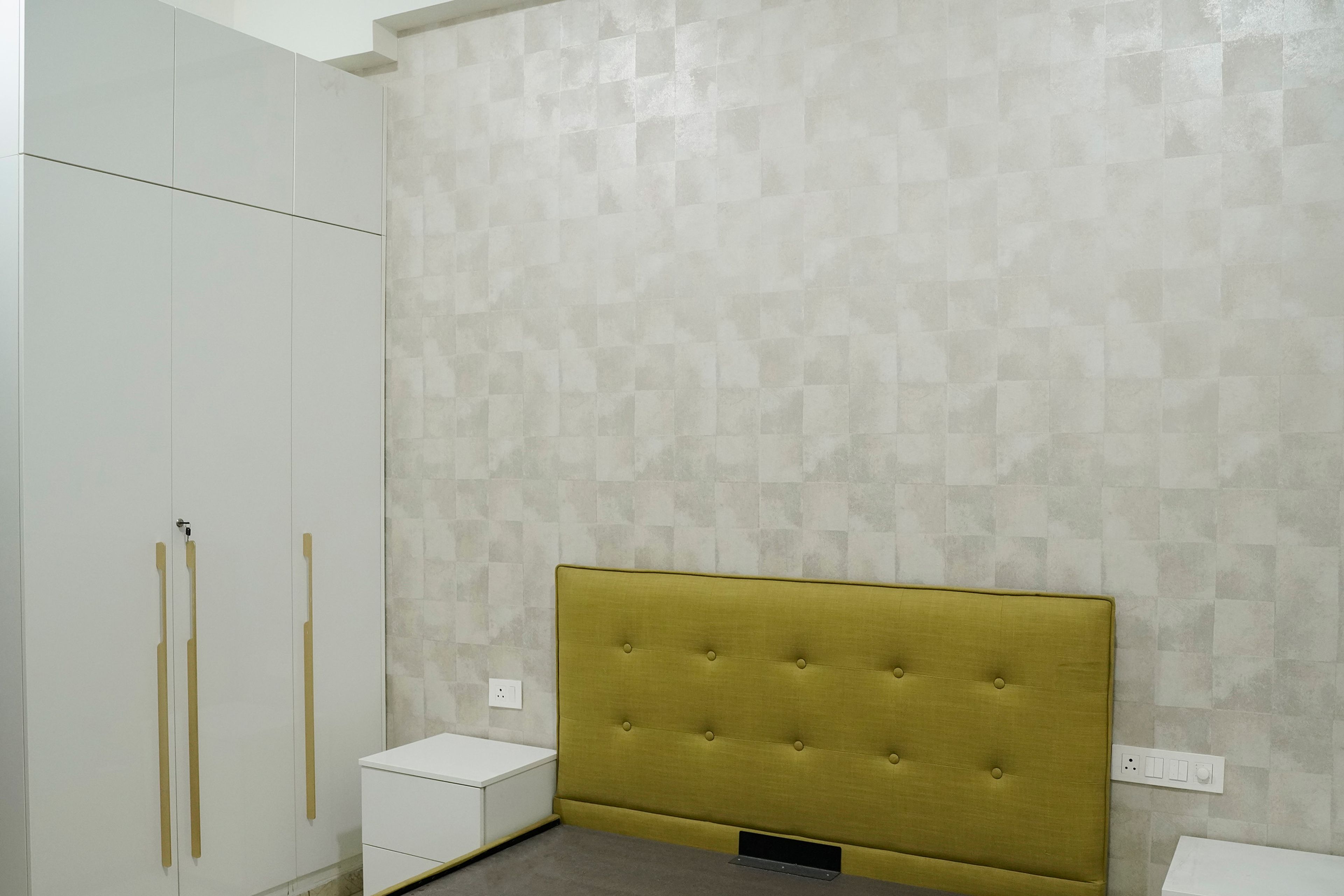 Bedroom Design with Green Headboard Bed, White Patterned Wallpaper and 3-Door Swing Wardrobe