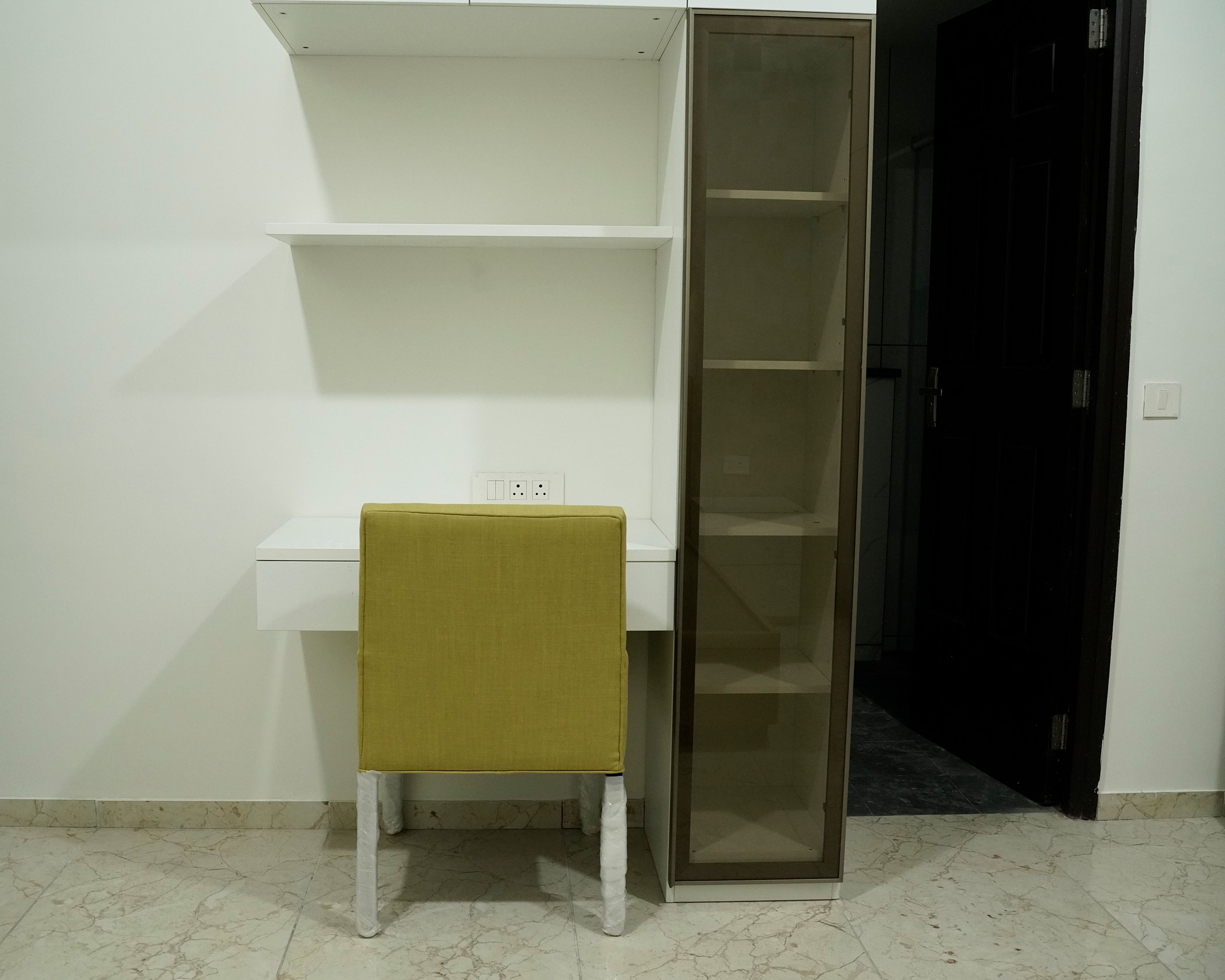 Study Space with White Wall Shelves, Tall Unit and Green Chair