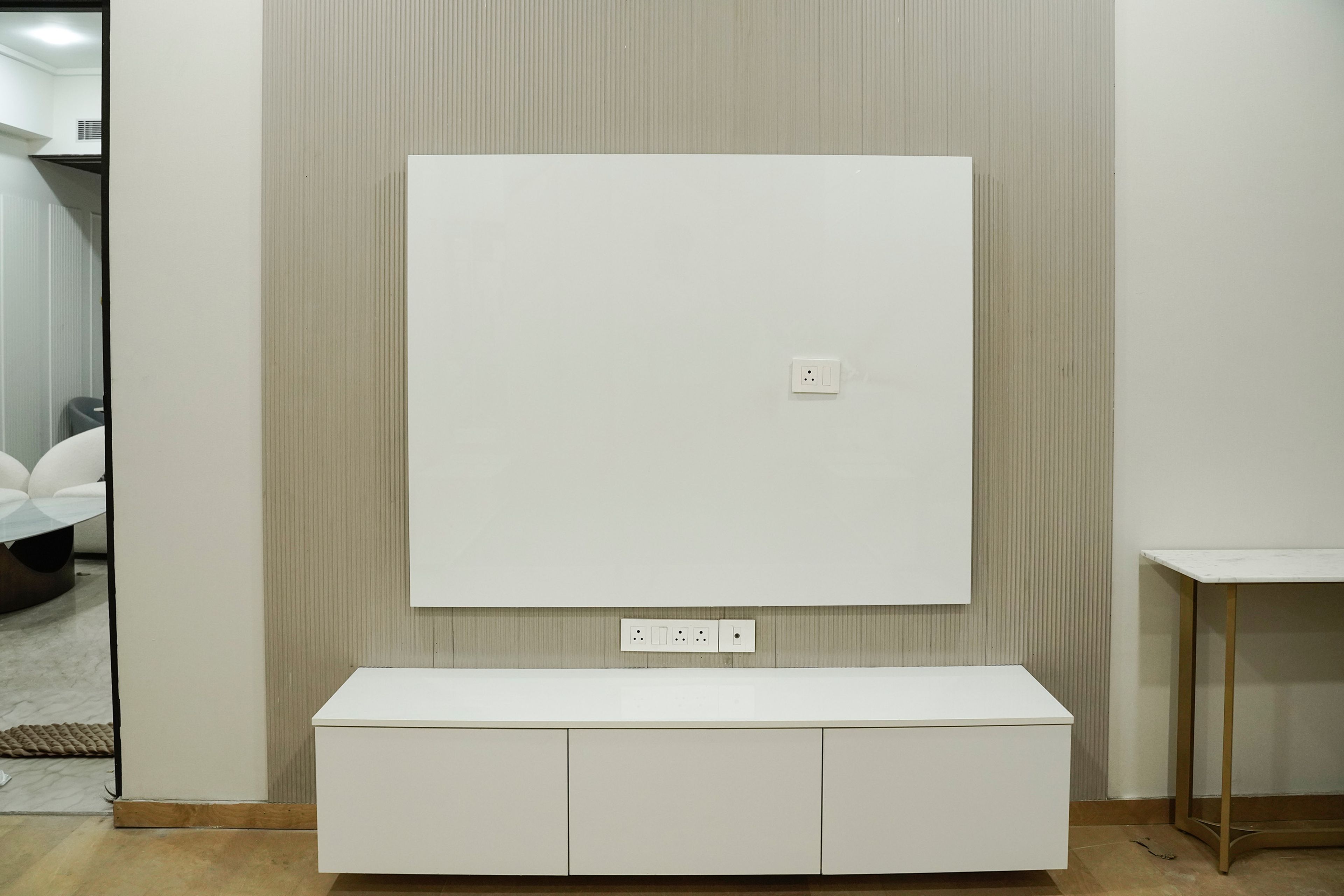 White TV Unit Design with Drawers and Vertical Wall Slats Backsplash