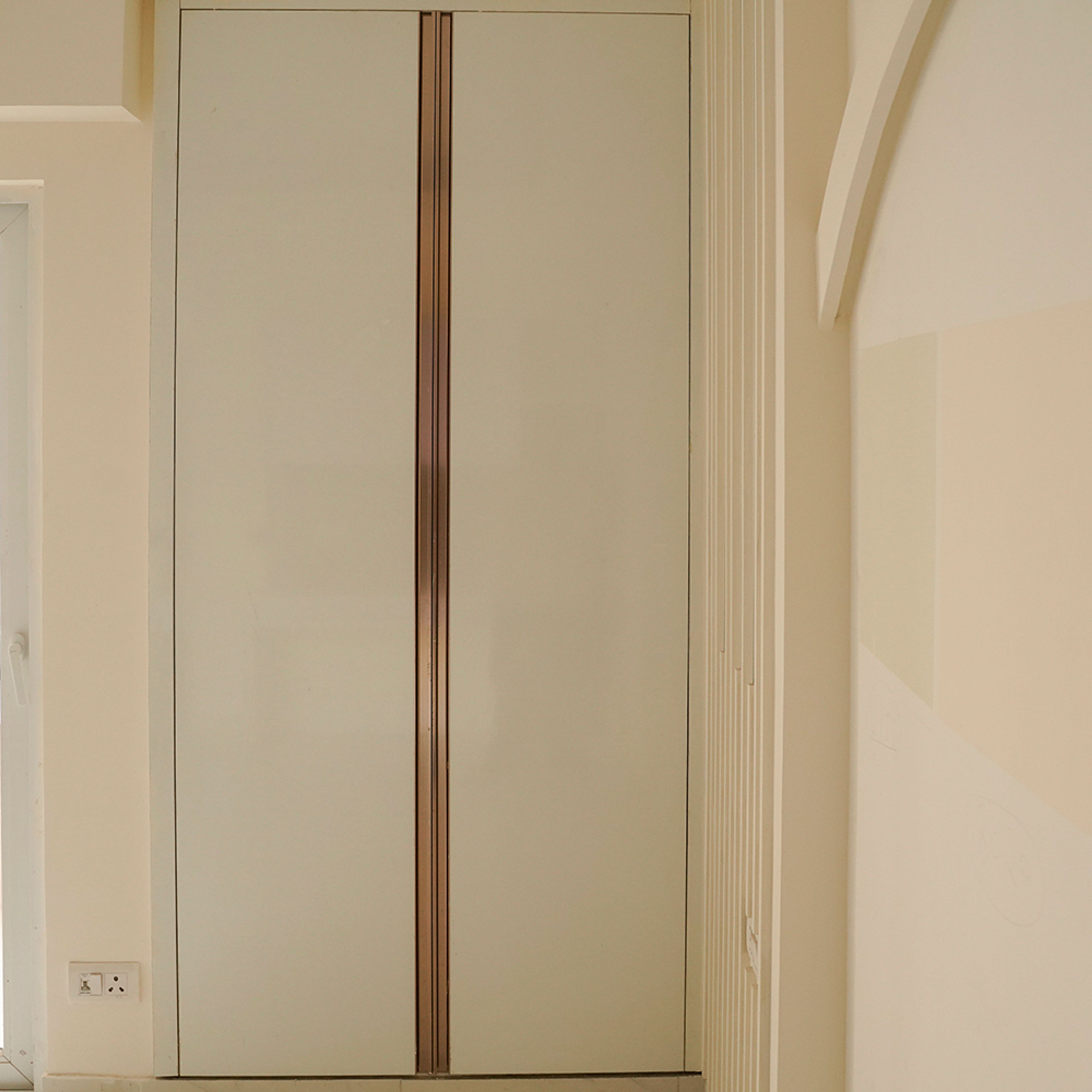 2-Door Cream Swing Wardrobe Design With Metallic Vertical Accent