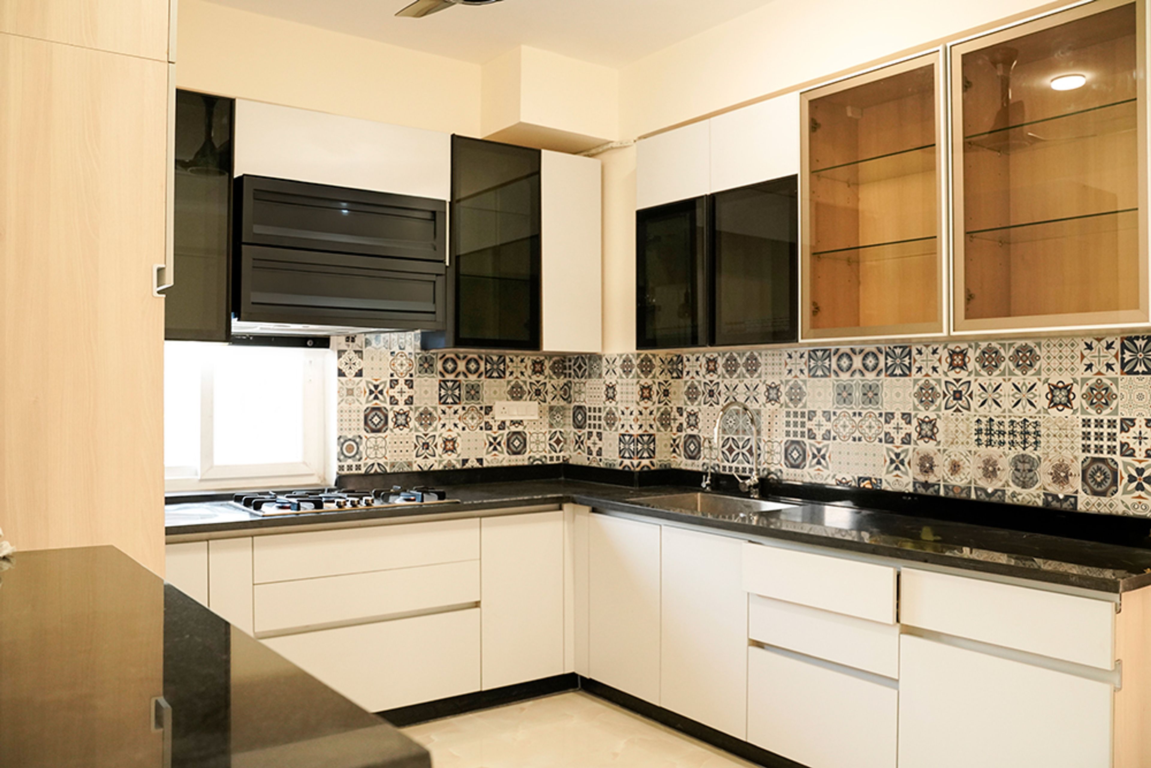 L-Shaped Kitchen Design with Moroccan Tiles Backsplash and Cream Cabinets