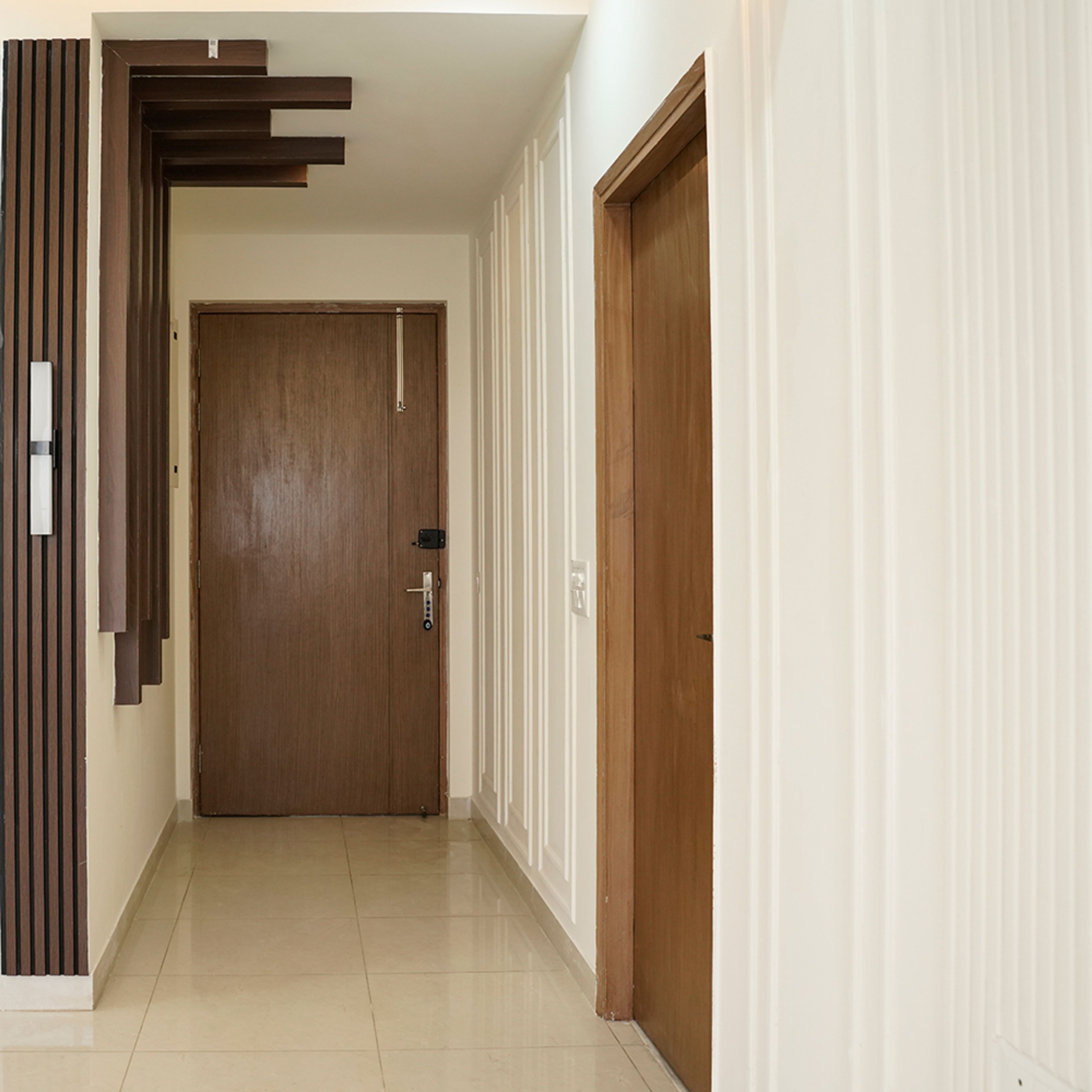 Contemporary Foyer Design with Wooden Swing Single Door in Noida 3BHK Apartment