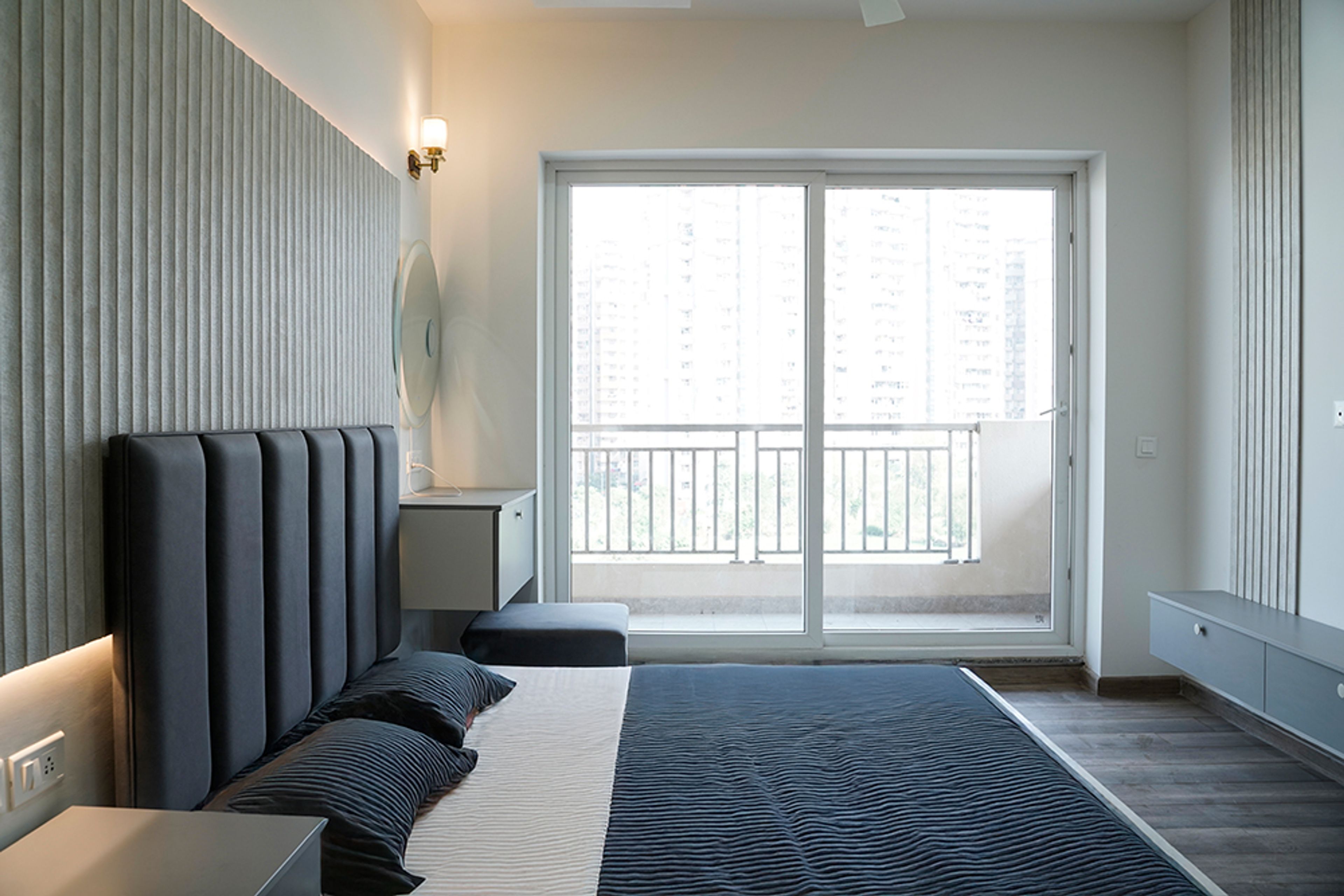 Bedroom Design with Tufted Blue Headboard Bed and Textured White Headboard Wall