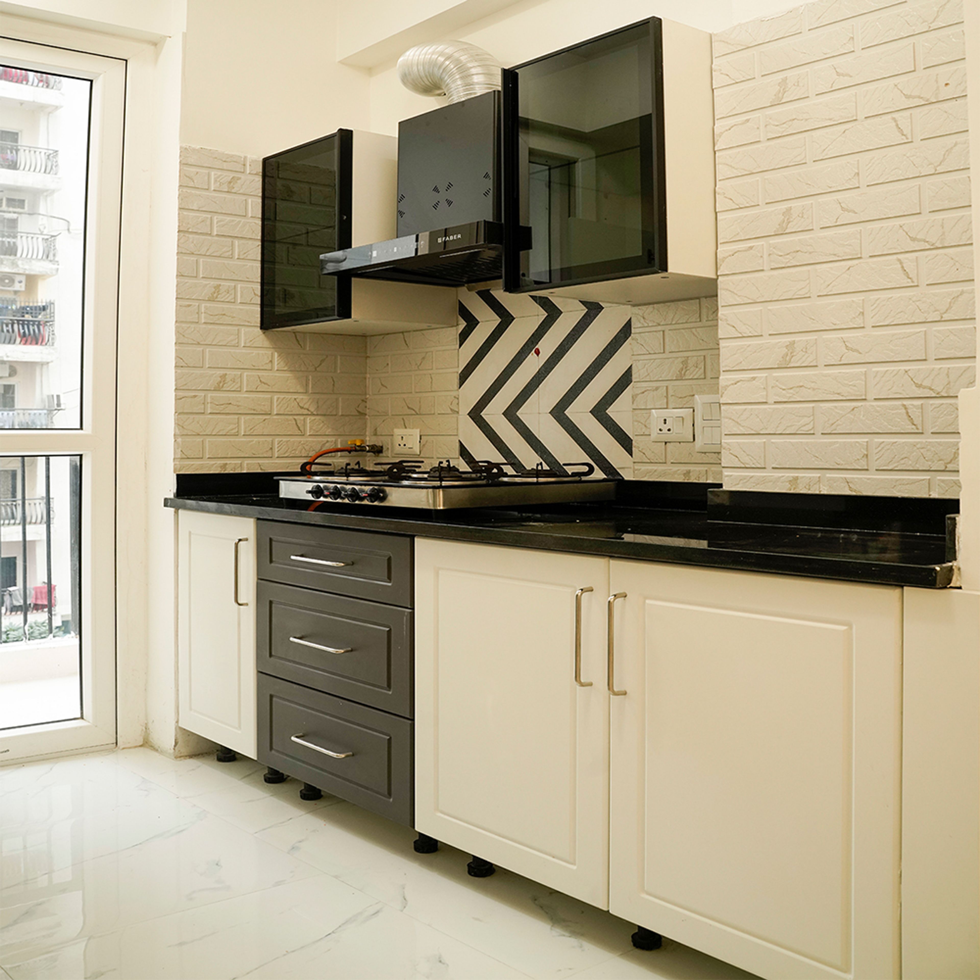 Parallel Kitchen Design with Cream and Black Units and Brock Pattenred Cream Backsplash