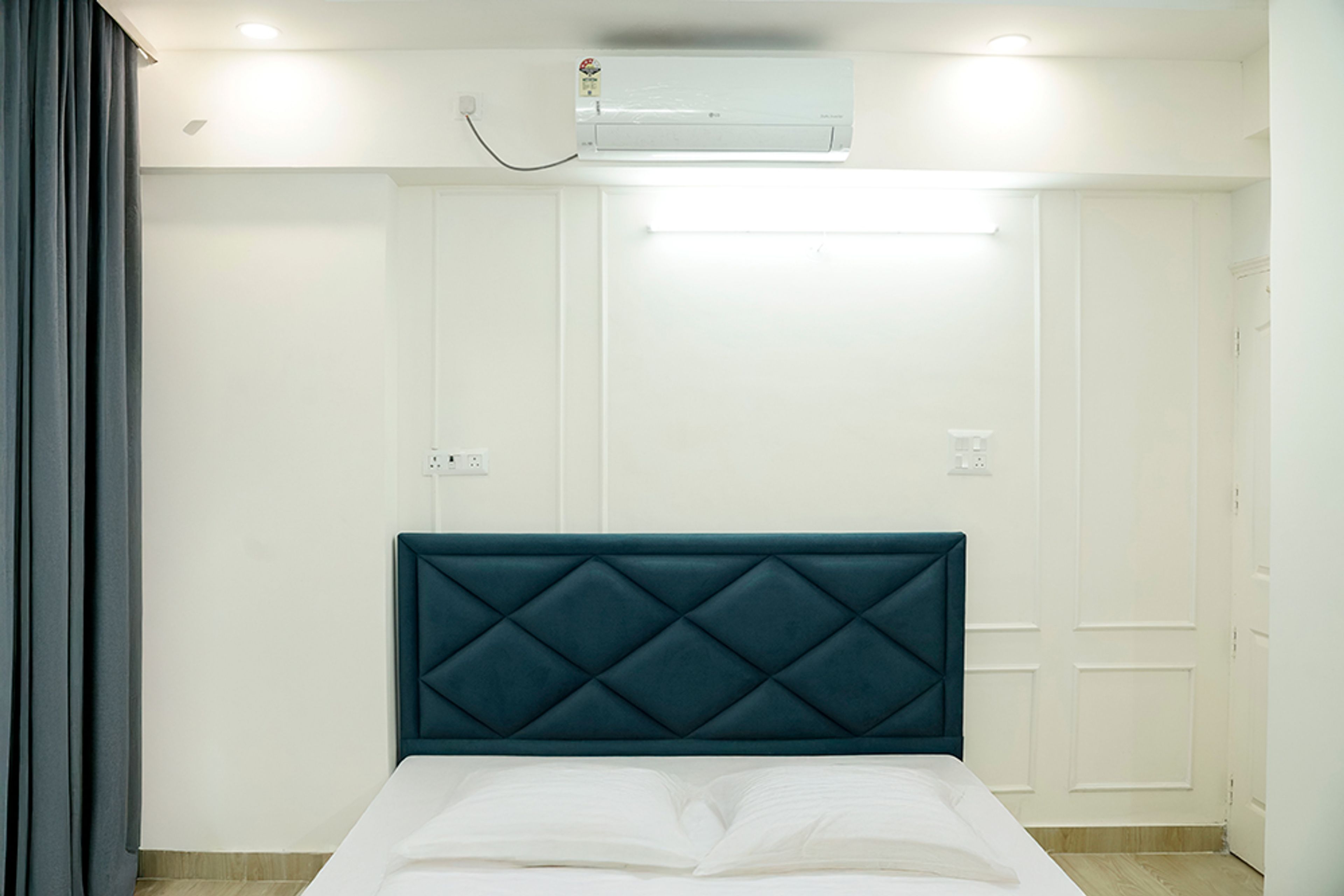 Bedroom Design with Teal Green Tufted Headboard Bed and White Wall with Trims