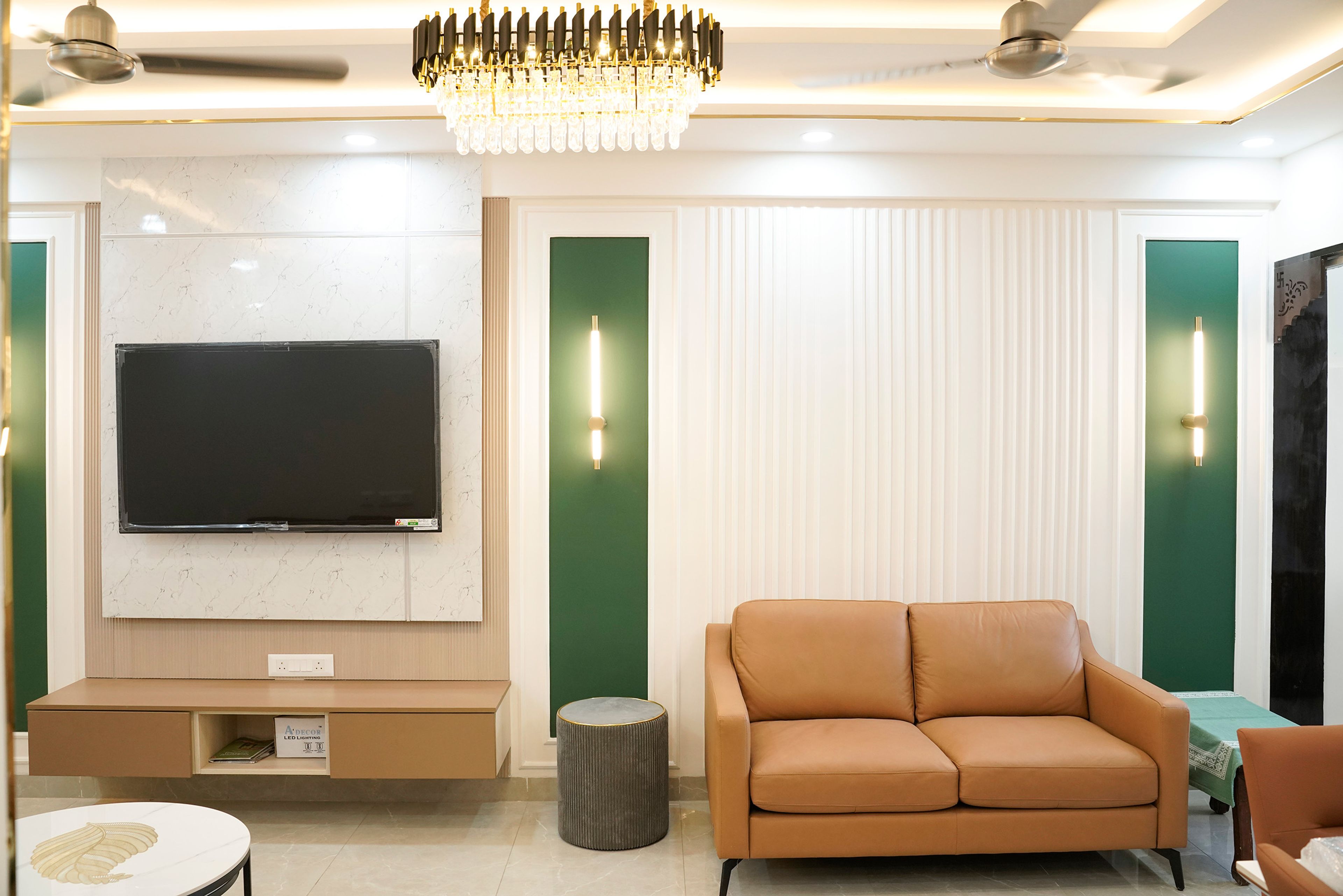 Living-cum-dining room with green and white walls with trims