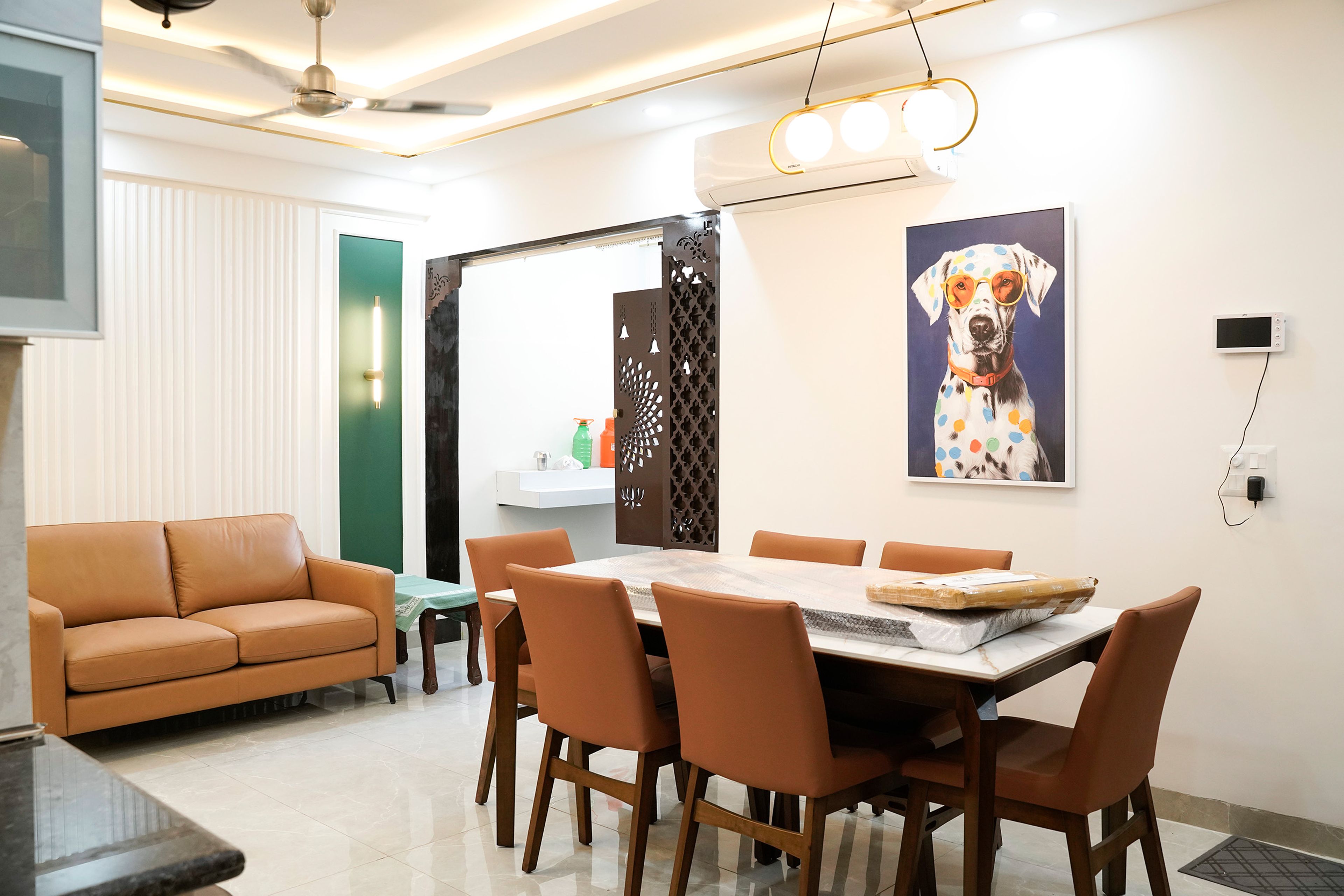 Living-cum-dining room with brown dining chairs and marble top table