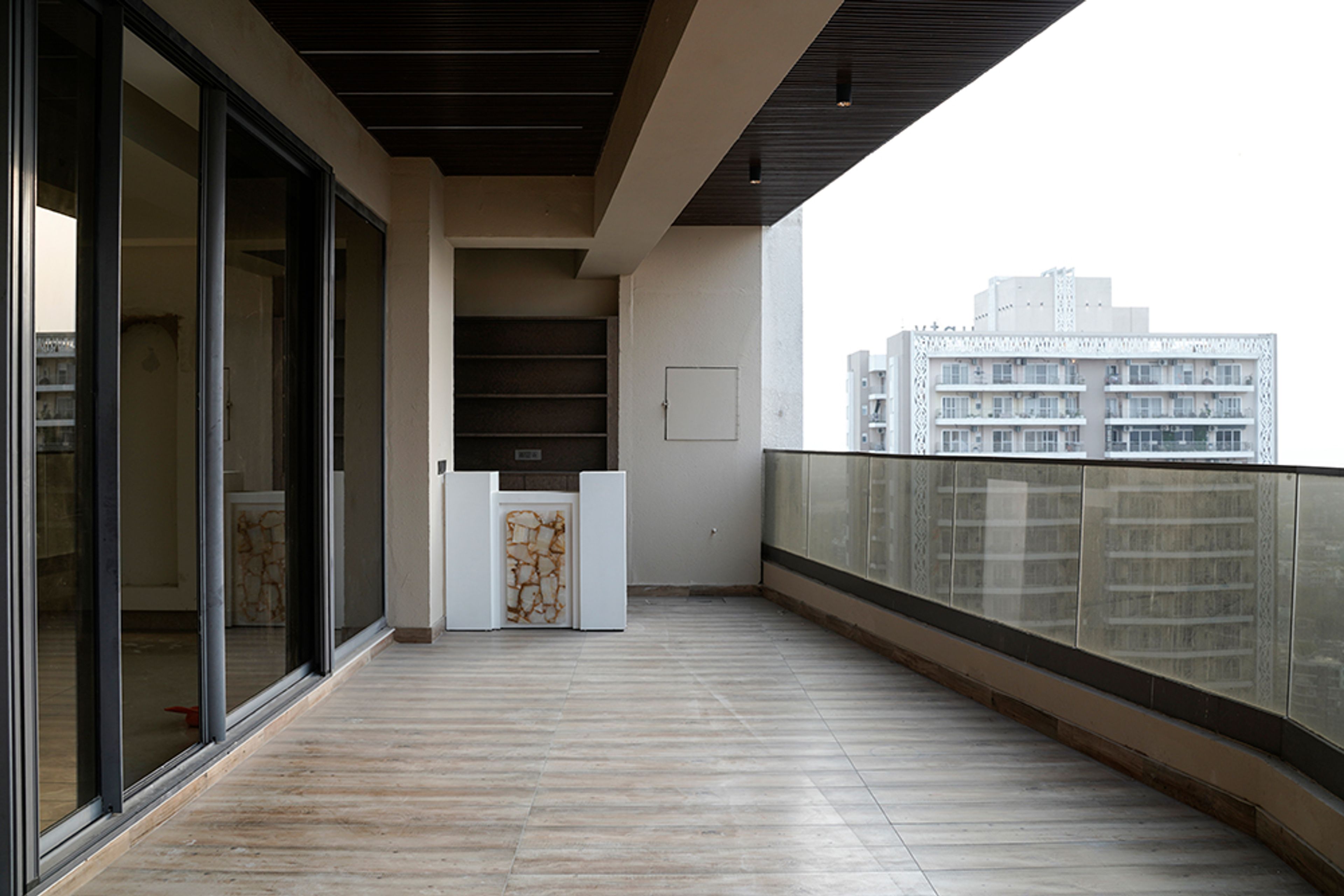 Blacony Design with Wooden Flooring and Glass Railing