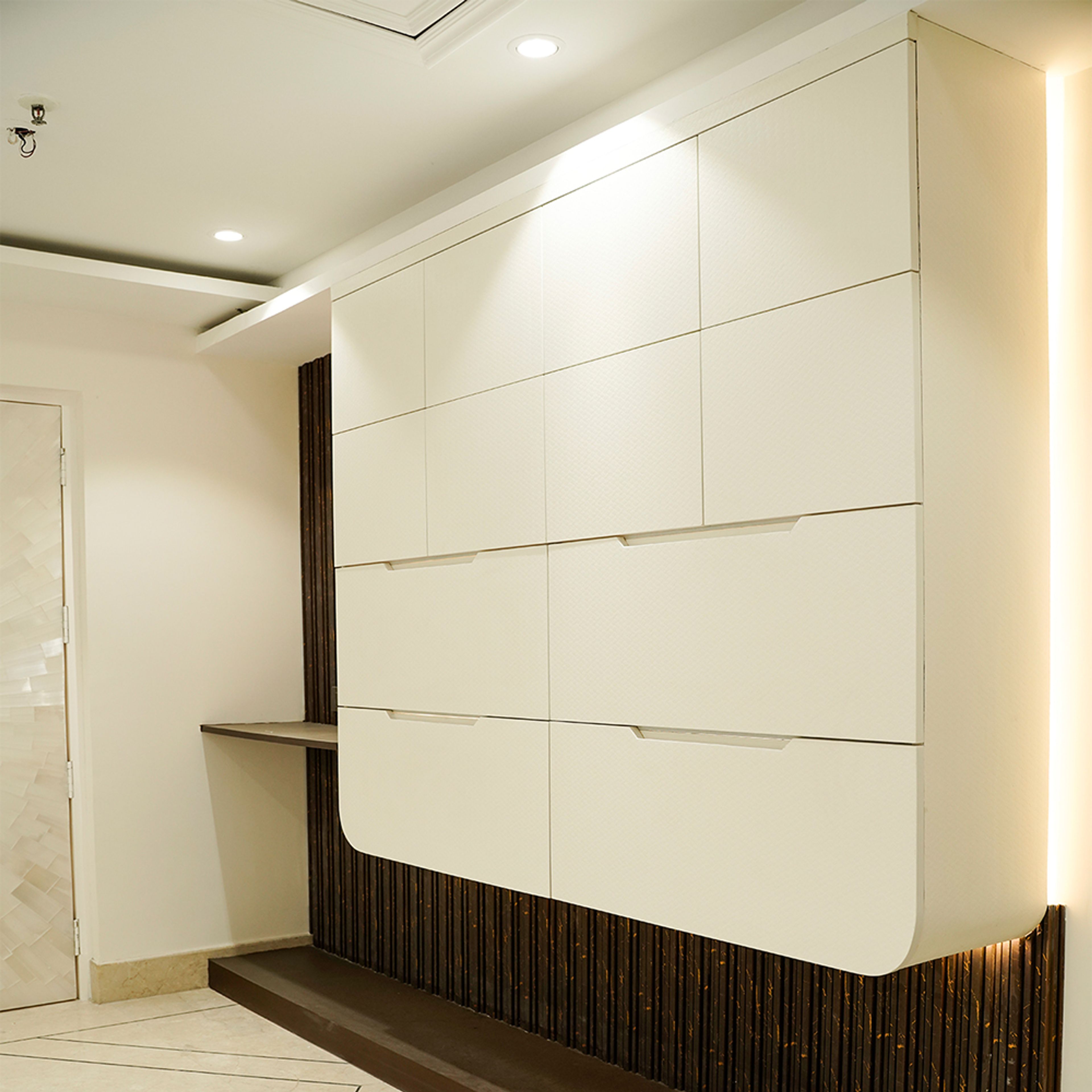 Wall-Mounted Wardrobe With Brown Panels and Attached Study Unit